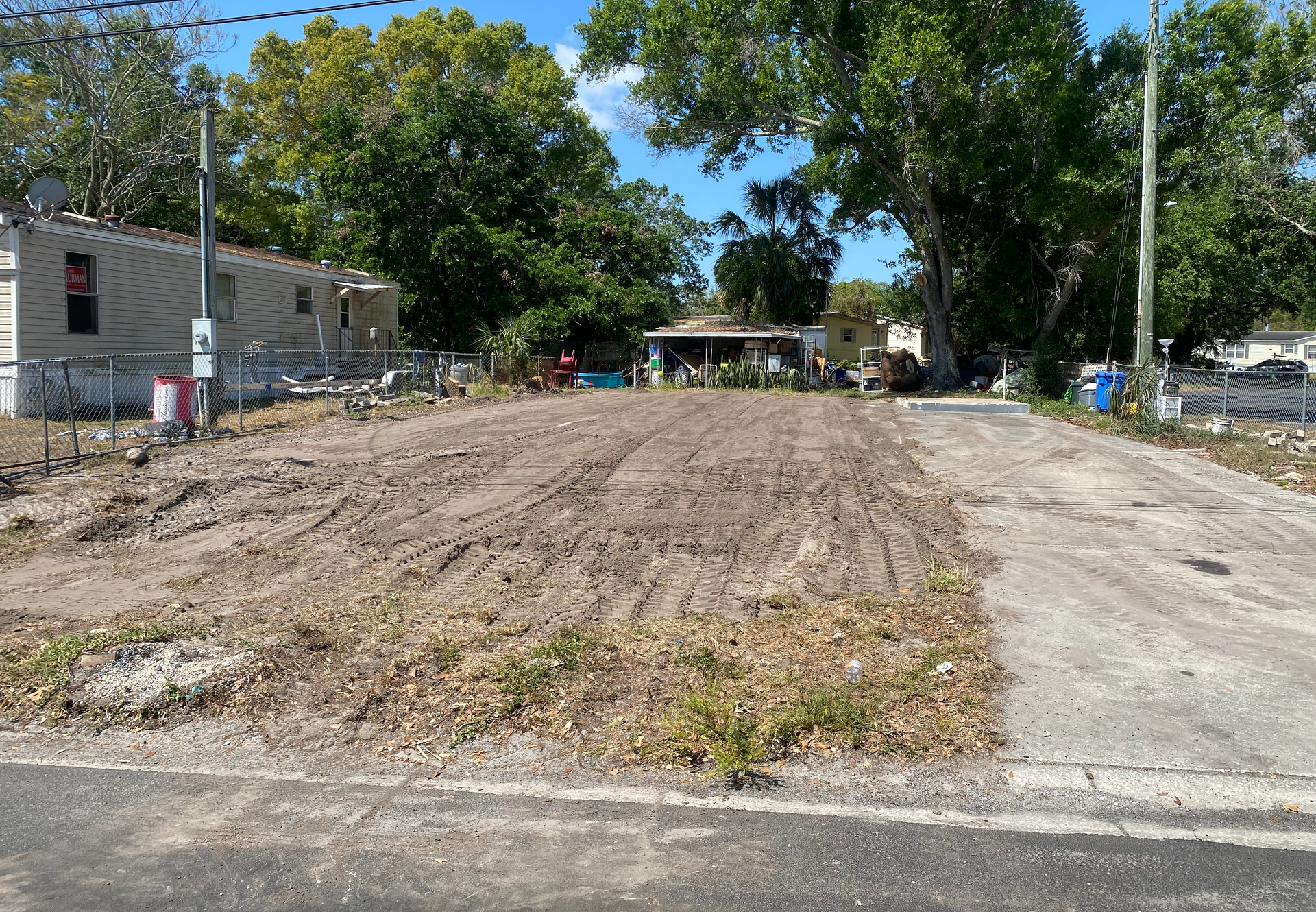 A dirt road with a lot of trees on the side of it