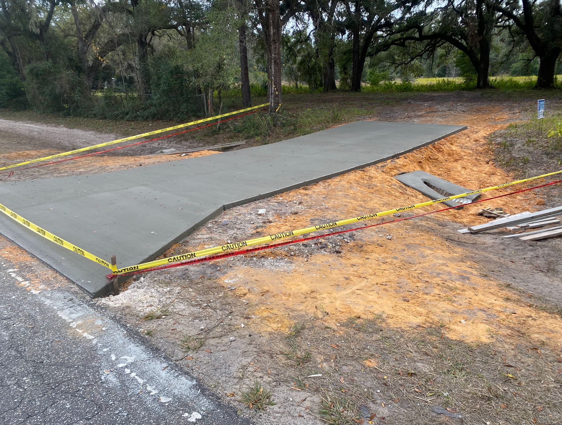 A concrete driveway is being built next to a road.