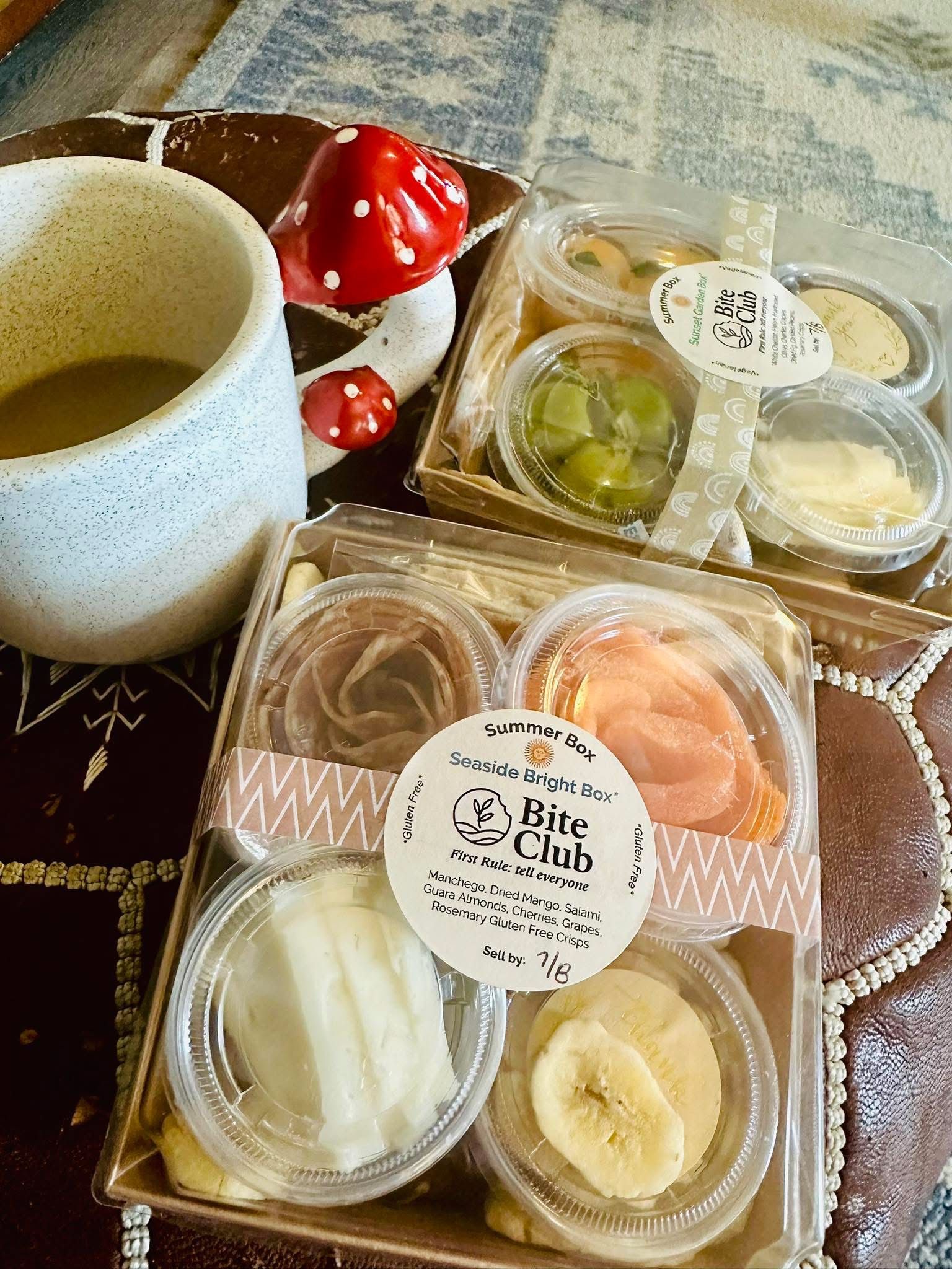 Charcuterie boxes with coffee and mushroom decor.