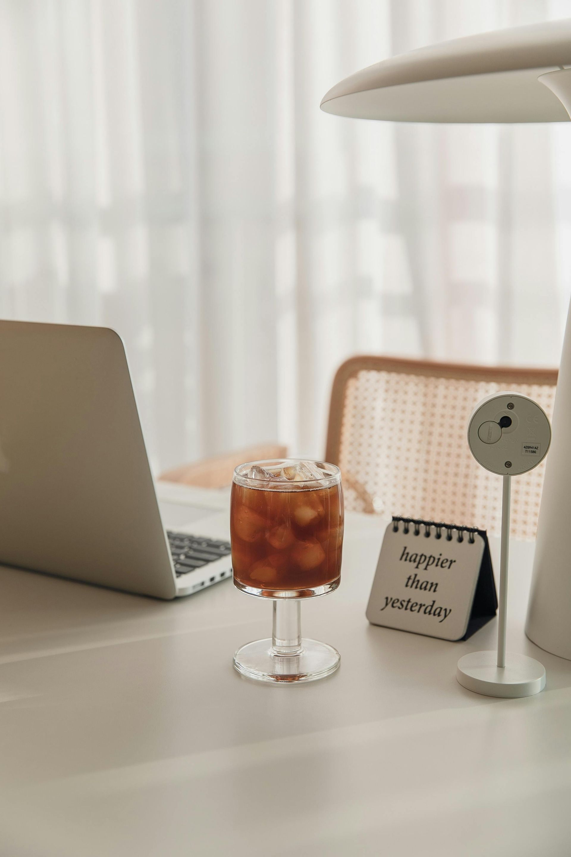 Laptop, iced coffee, desk lamp, and 