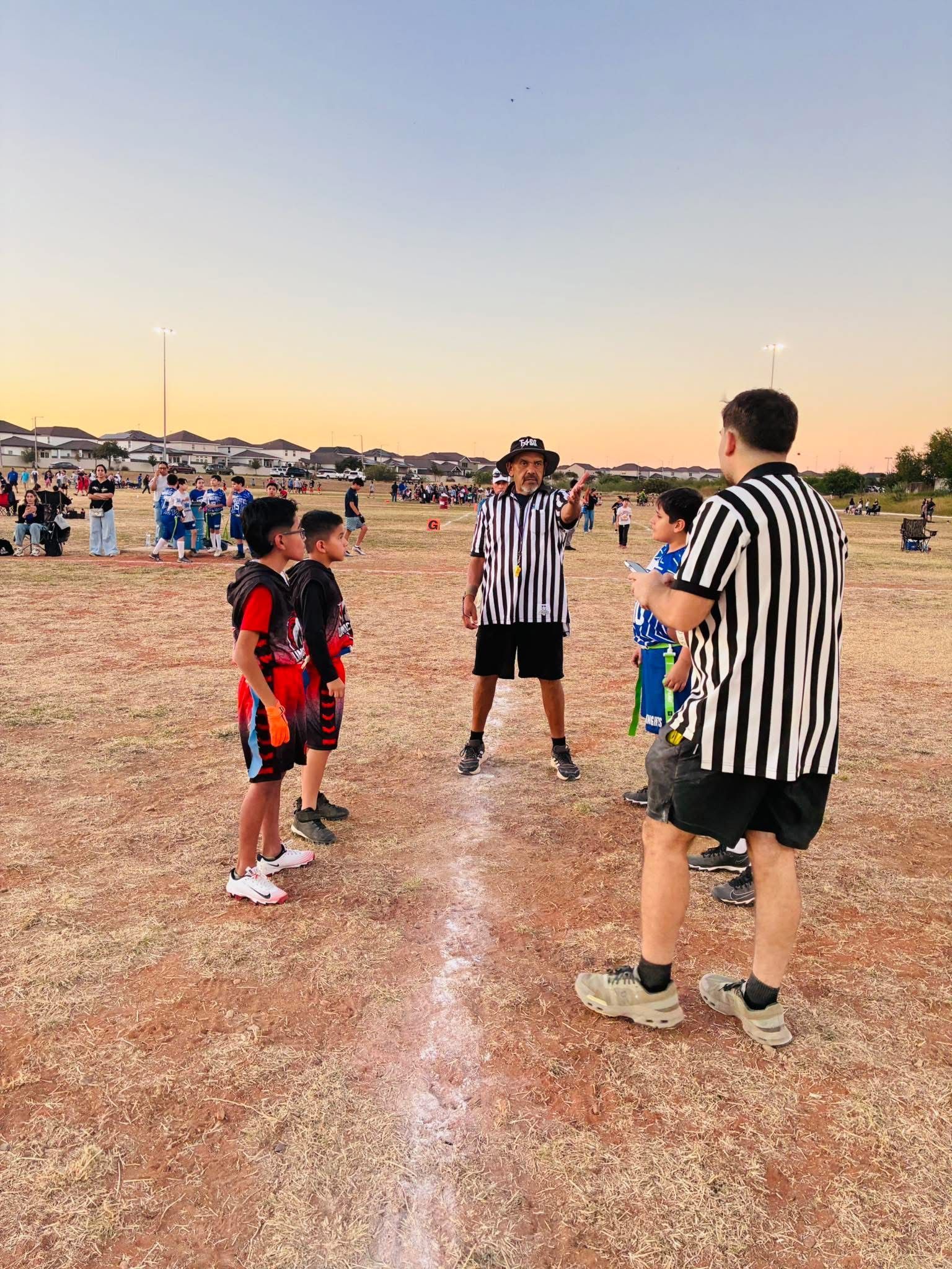 Baseball player sliding into base as another player attempts to catch the ball.