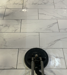A vacuum cleaner is sitting on a tiled floor.