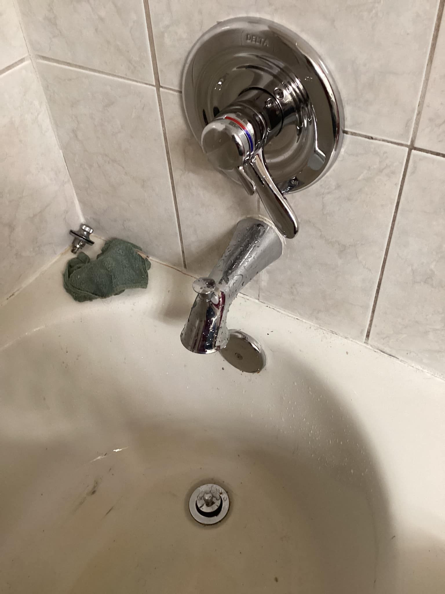 A bathtub with a faucet and a sponge in it.