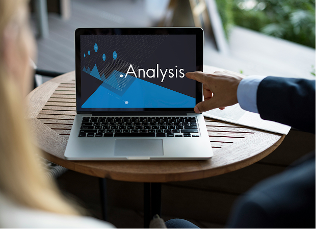 A person is pointing at a laptop screen that says analysis