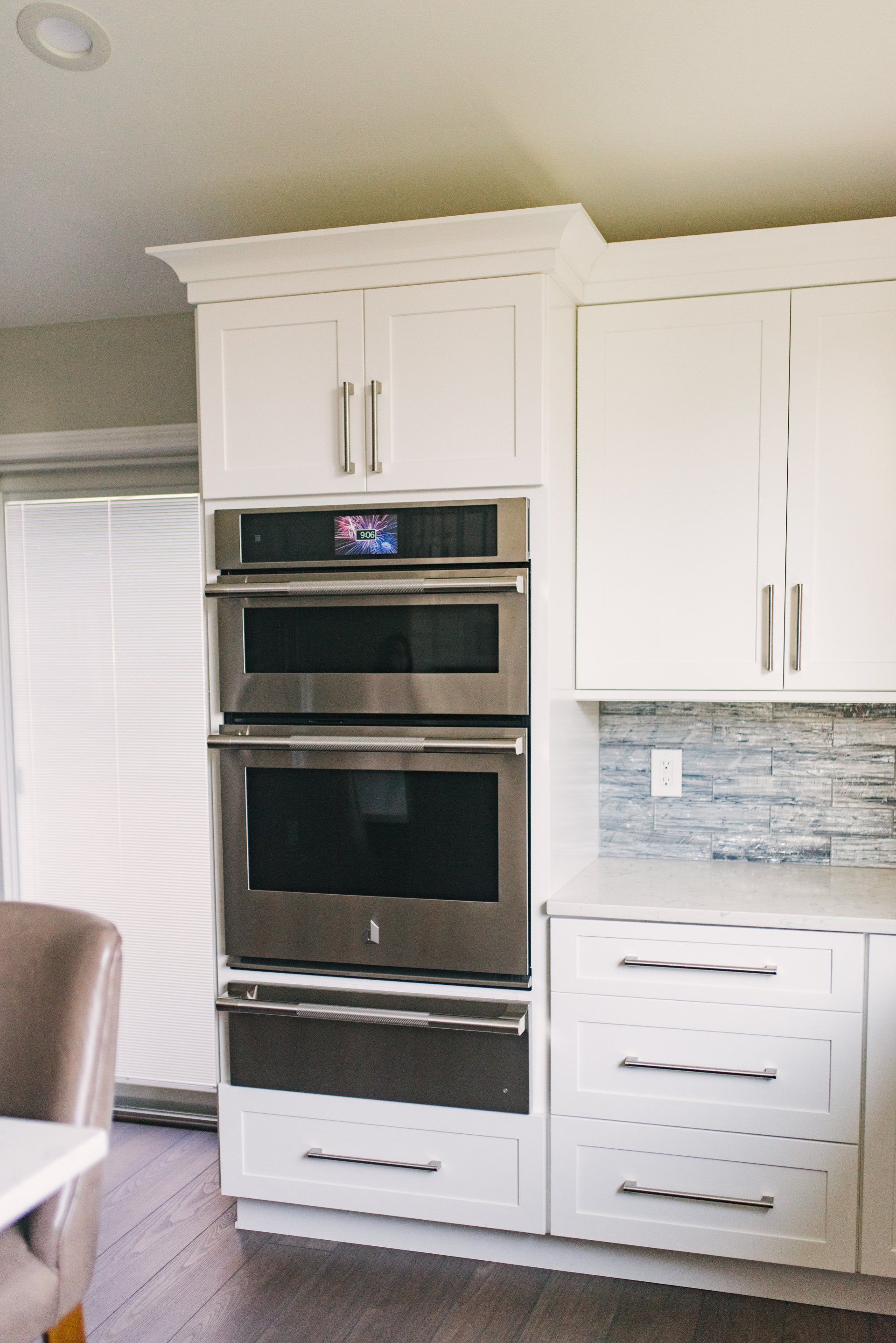 A kitchen with white cabinets and stainless steel appliances