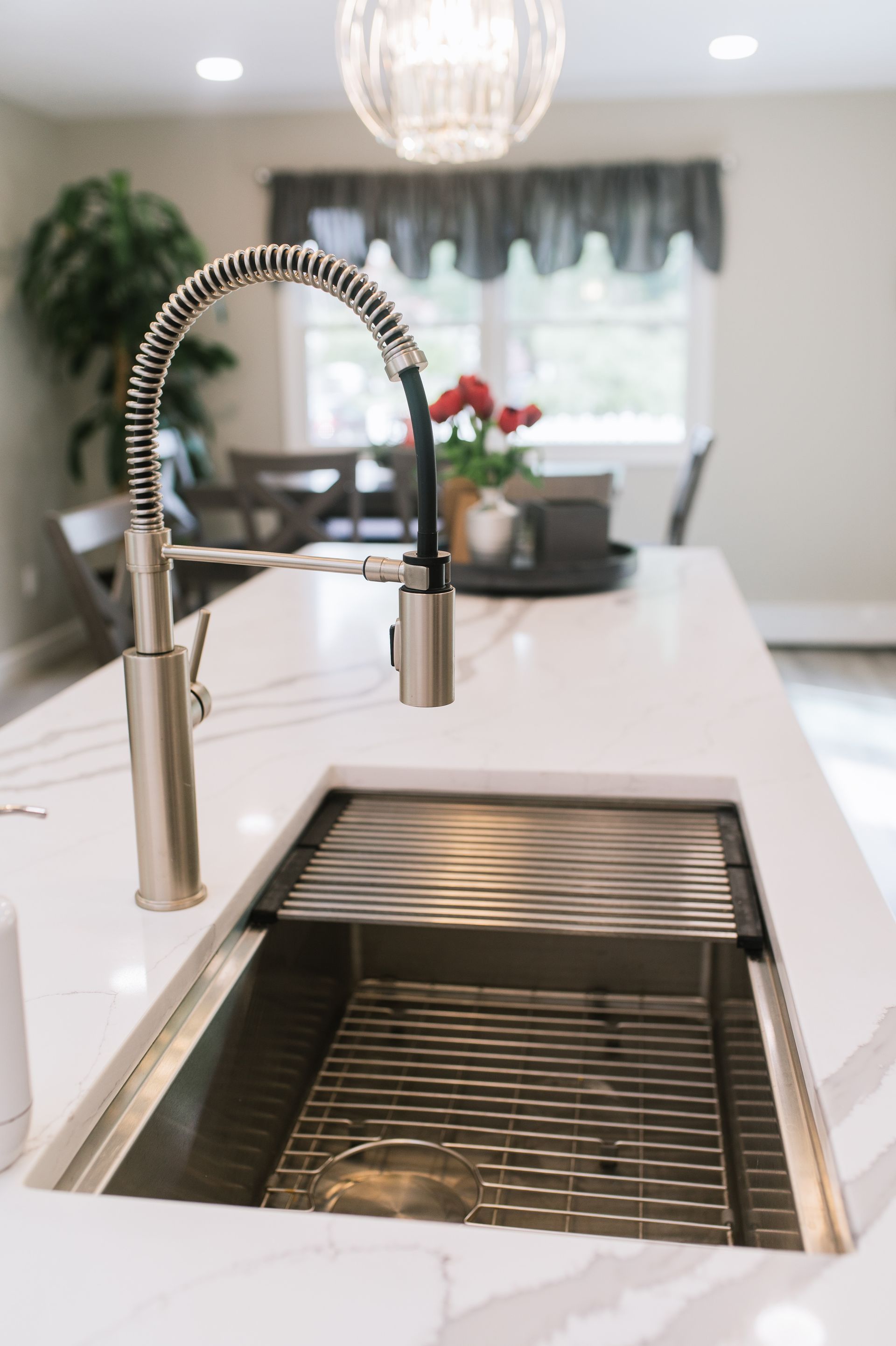 A kitchen sink with a faucet on top of it