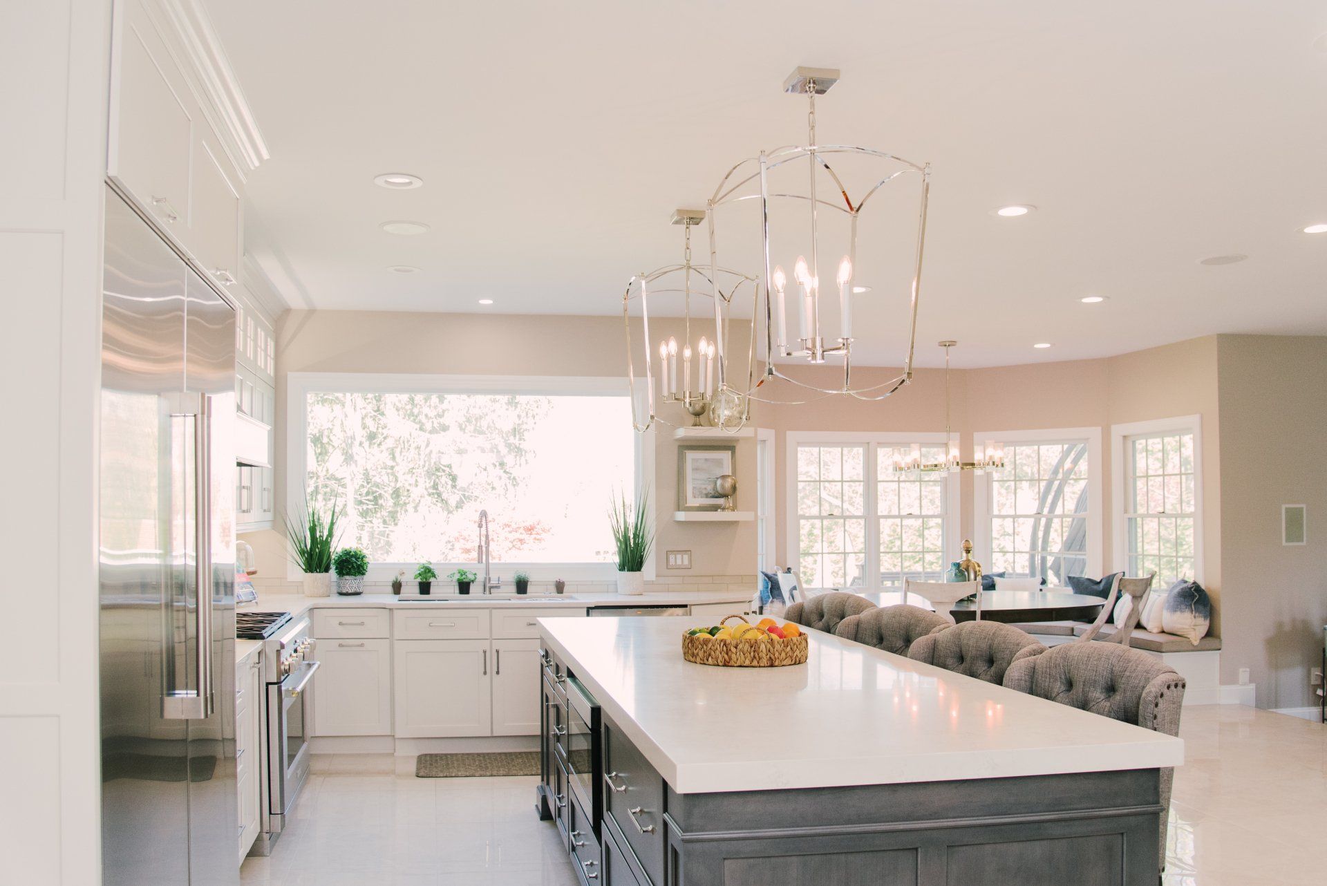 A kitchen with a large island and a chandelier hanging from the ceiling.