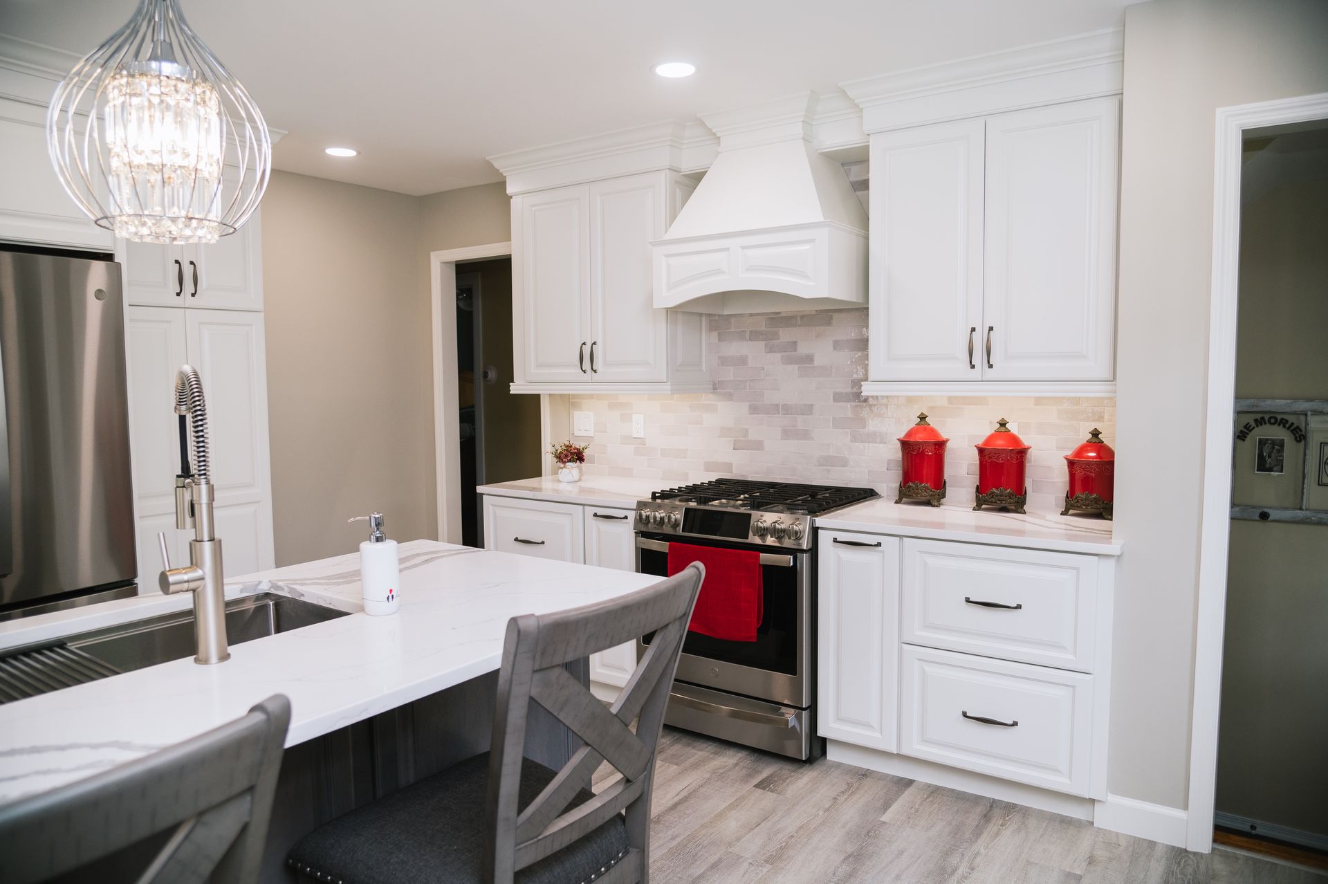 A kitchen with white cabinets and stainless steel appliances.