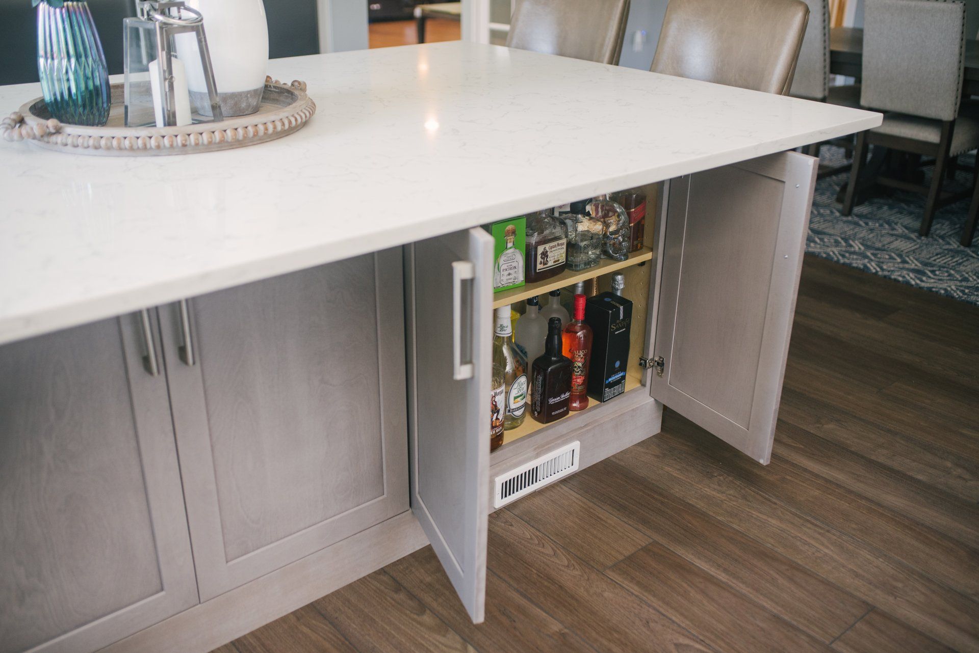 A kitchen island with a pantry underneath it.