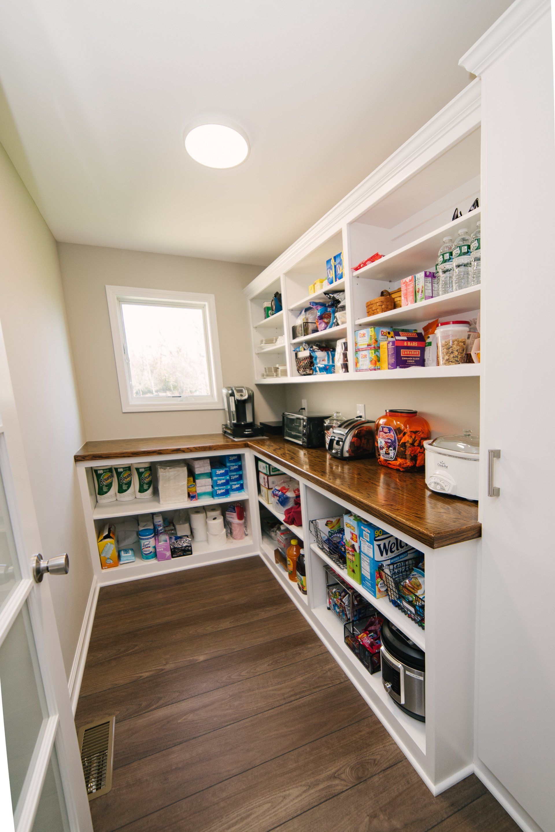 A pantry filled with lots of food and appliances.