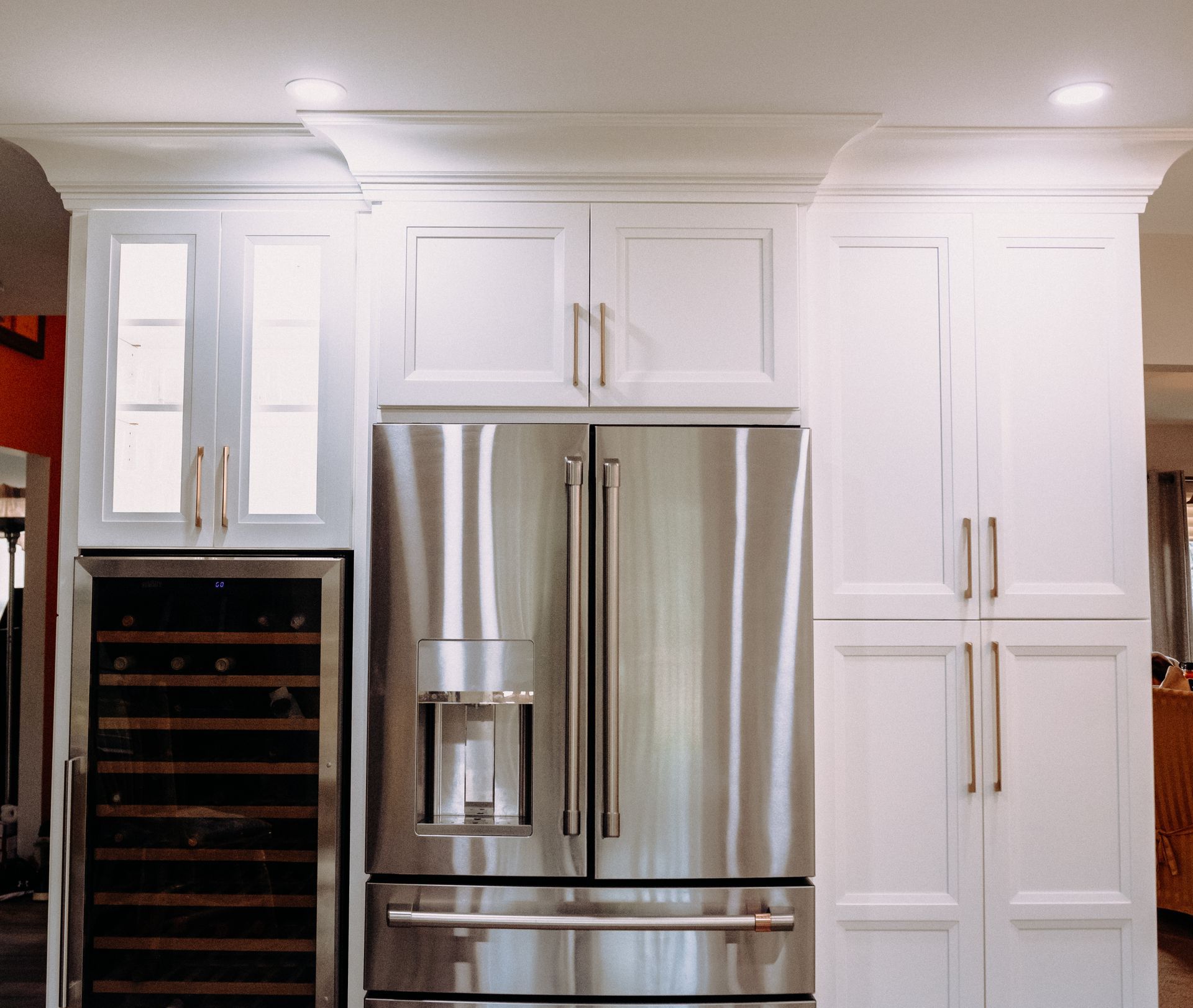 A kitchen with stainless steel appliances and white cabinets
