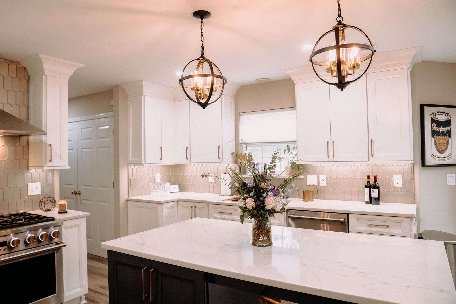 There is a vase of flowers on the counter in the kitchen.