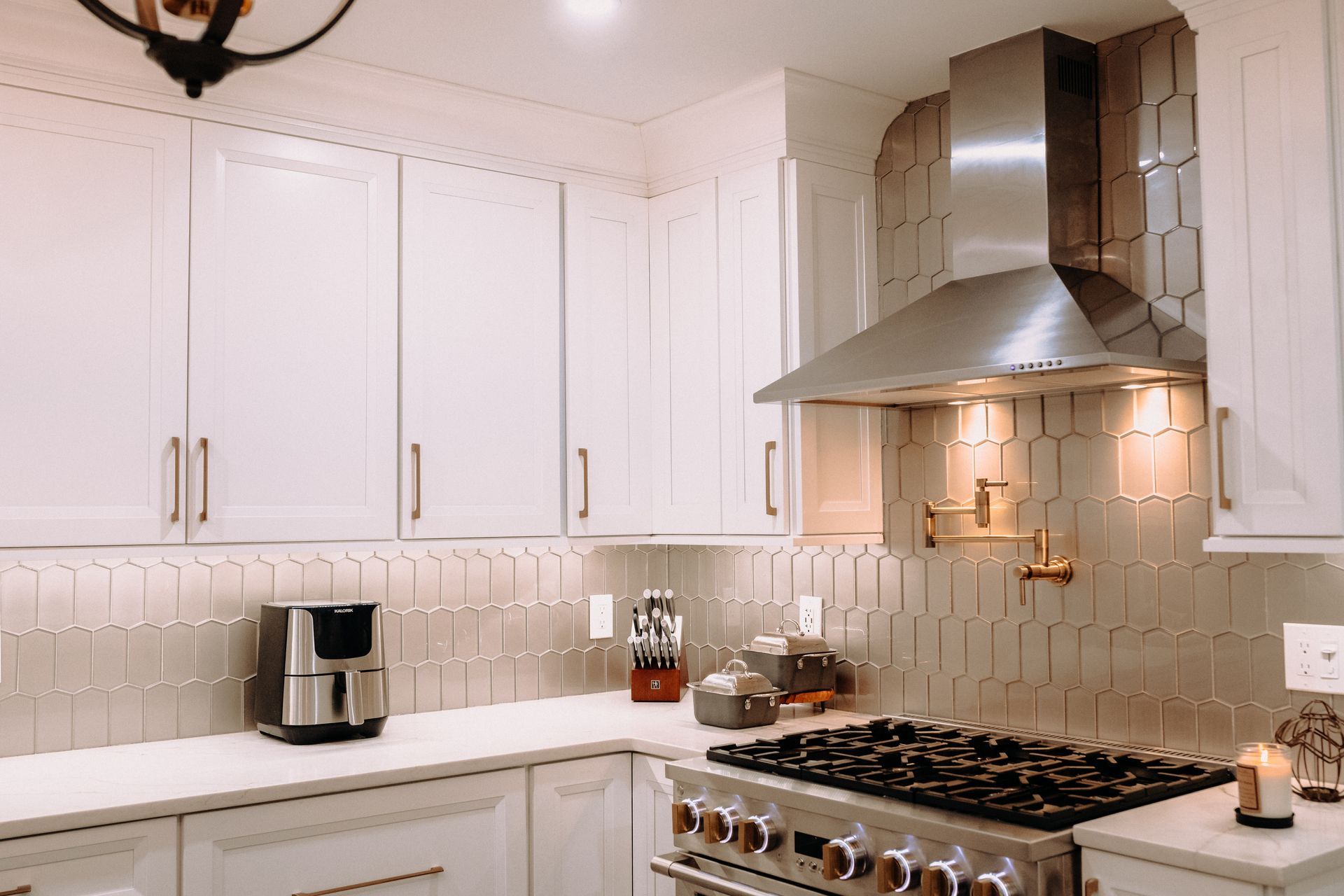 A kitchen with stainless steel appliances and white cabinets