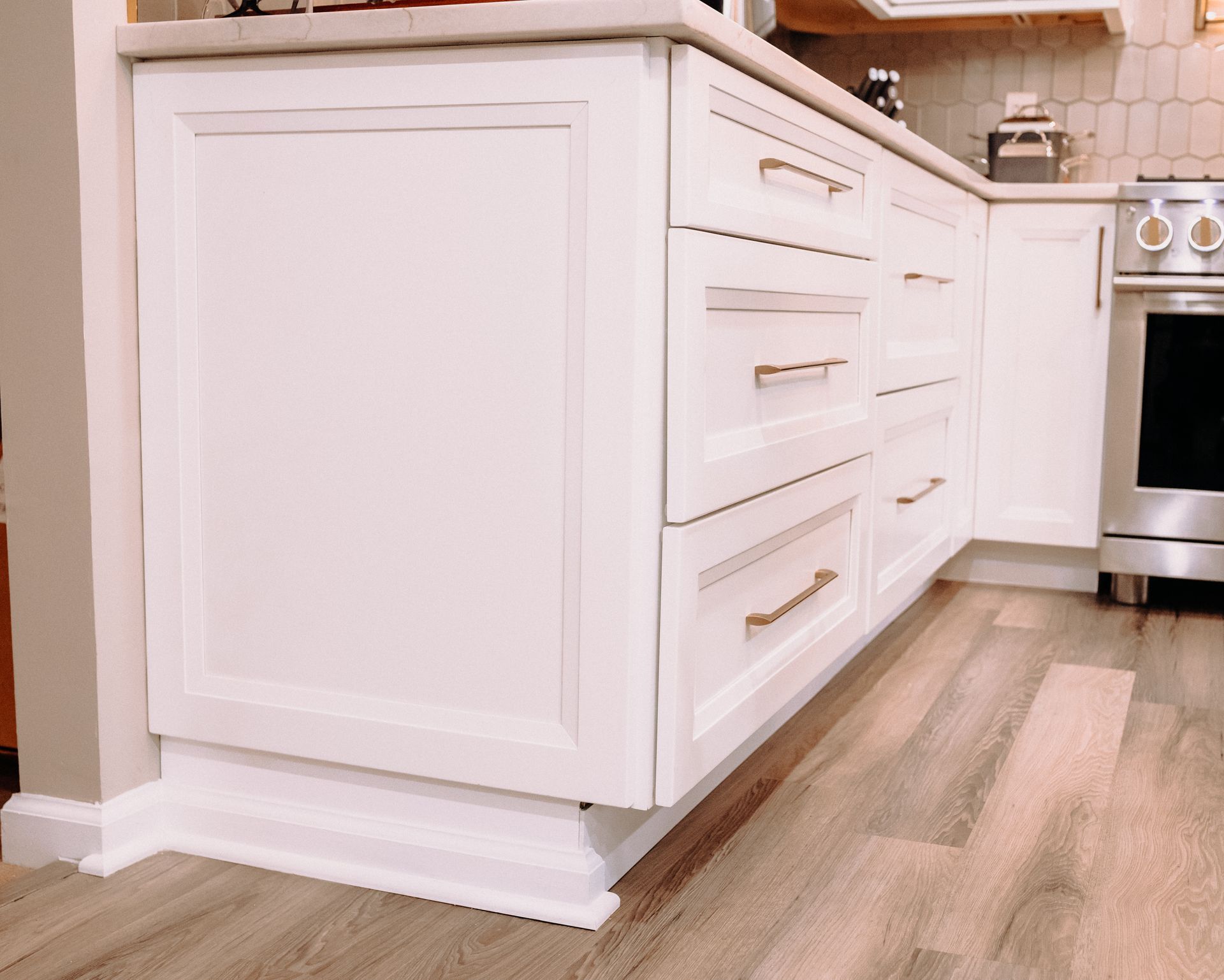 A kitchen with white cabinets and stainless steel appliances.