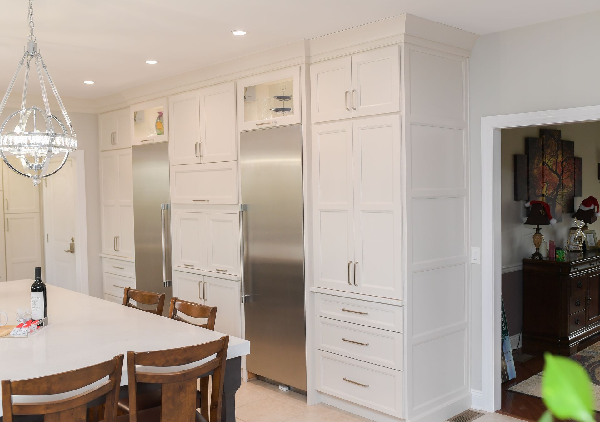 A kitchen with white cabinets and stainless steel appliances
