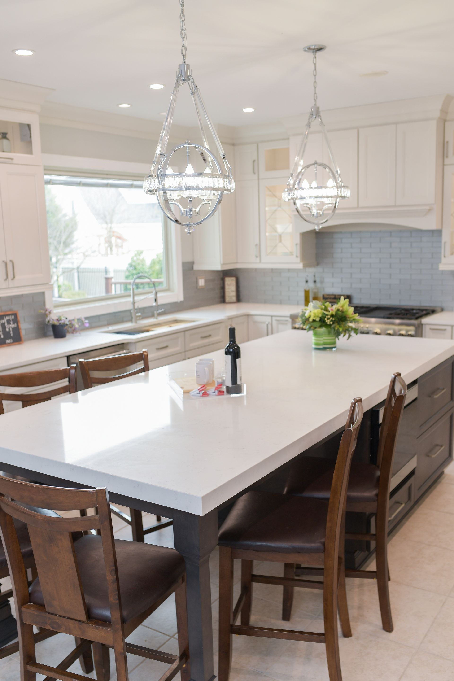 A kitchen with a table and chairs and a bottle of wine on it