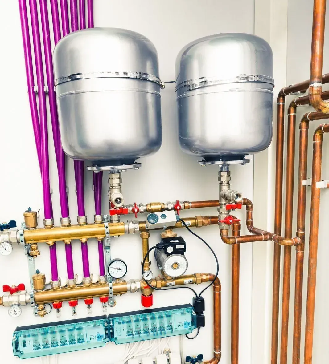 Two stainless steel tanks are connected to copper pipes