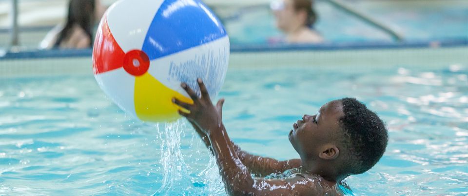 KEEEN Athletes in Pool with large beach ball