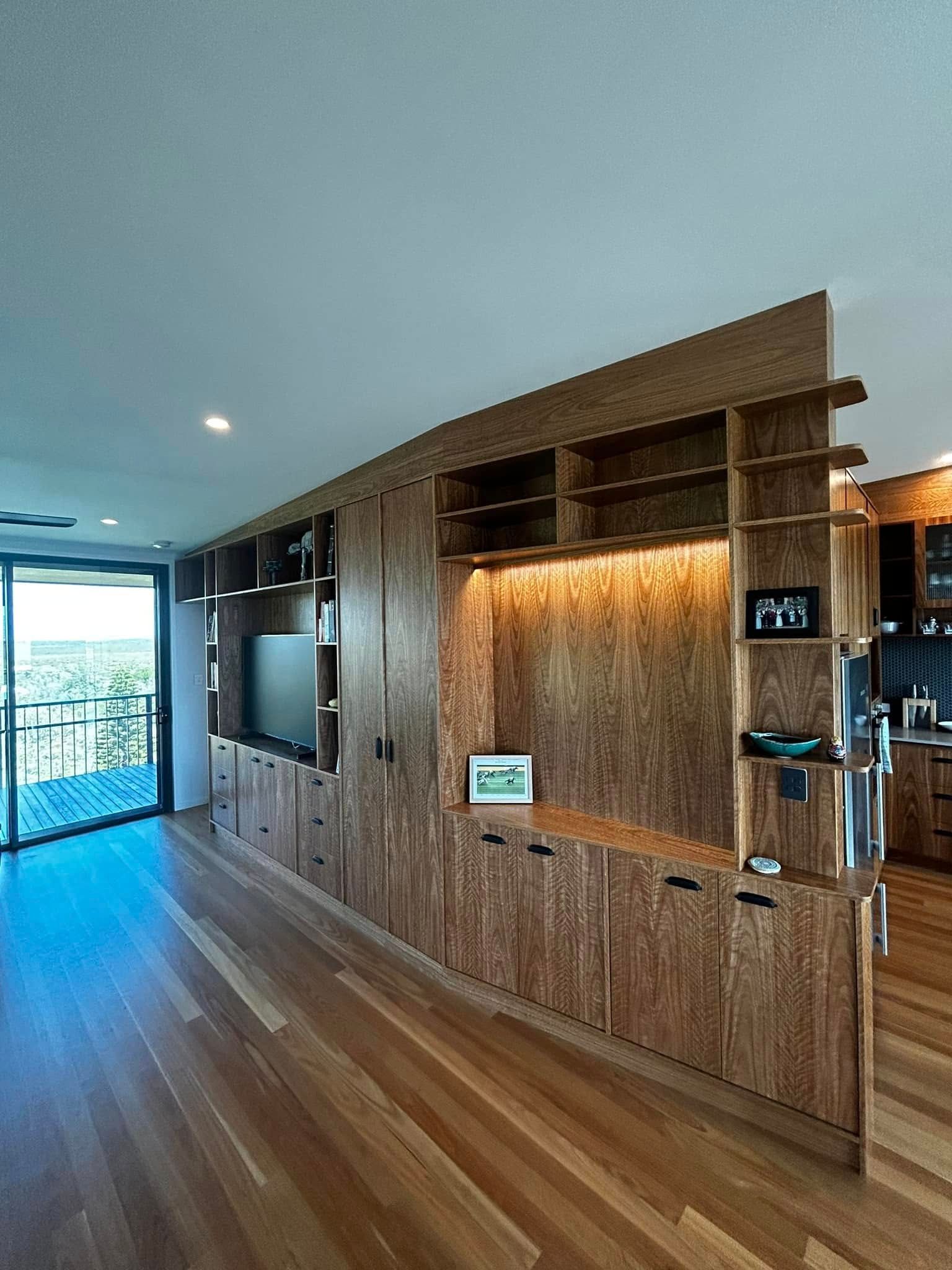 A Living Room With Wooden Cabinets and a Flat Screen TV — Pacific Cabinets In Yamba, NSW