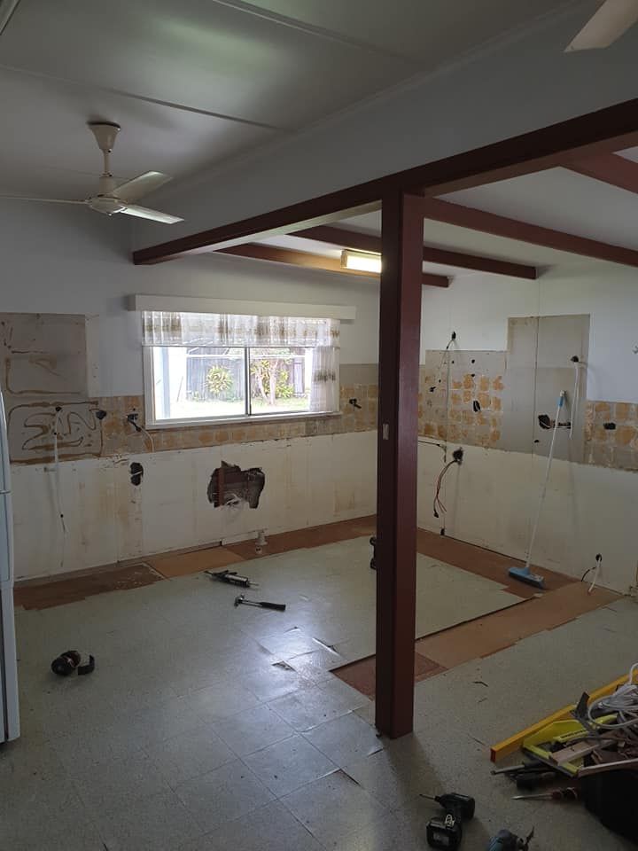 An Empty Kitchen With a Ceiling Fan and a Window — Pacific Cabinets In Yamba, NSW