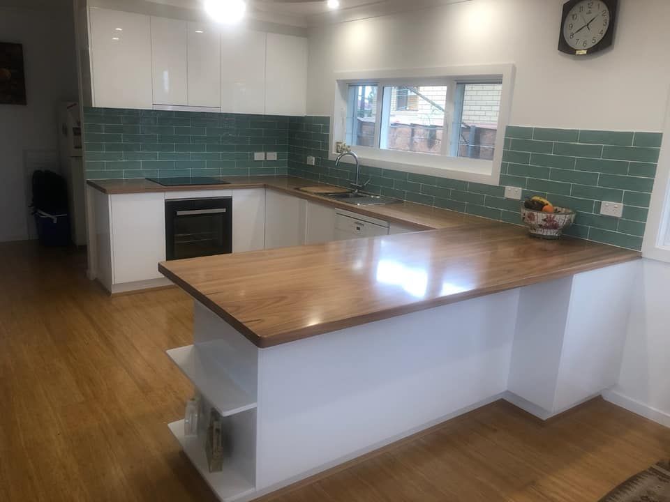 A Kitchen With White Cabinets and a Wooden Counter Top — Pacific Cabinets In Yamba, NSW