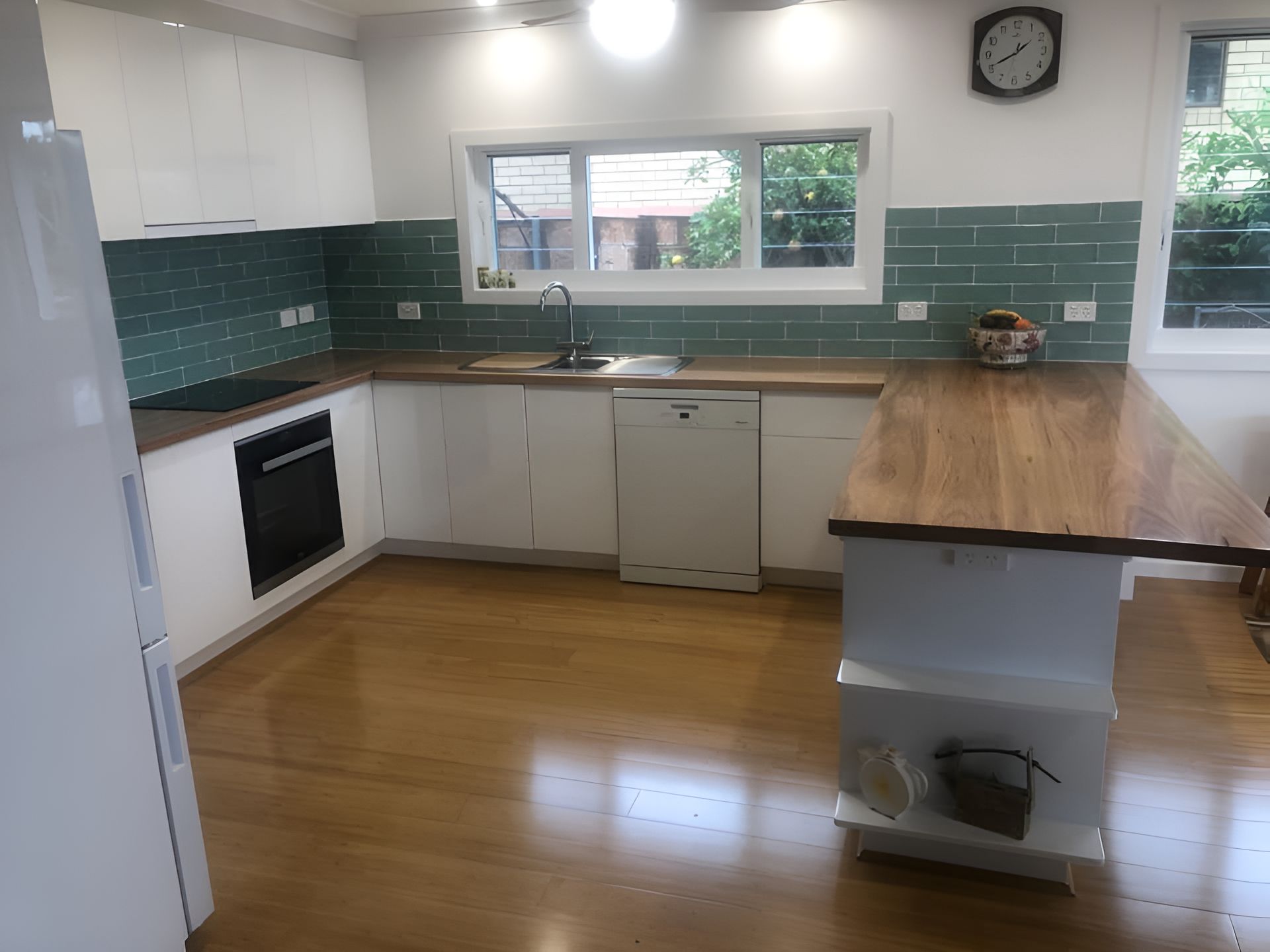 A Kitchen With White Cabinets and a Wooden Counter Top — Pacific Cabinets In Iluka, NSW