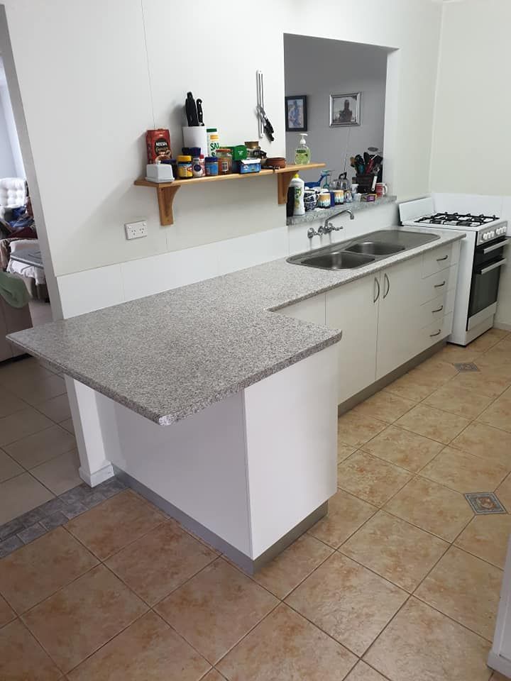 A Kitchen With A Sink , Stove , And Shelf — Pacific Cabinets In Yamba, NSW