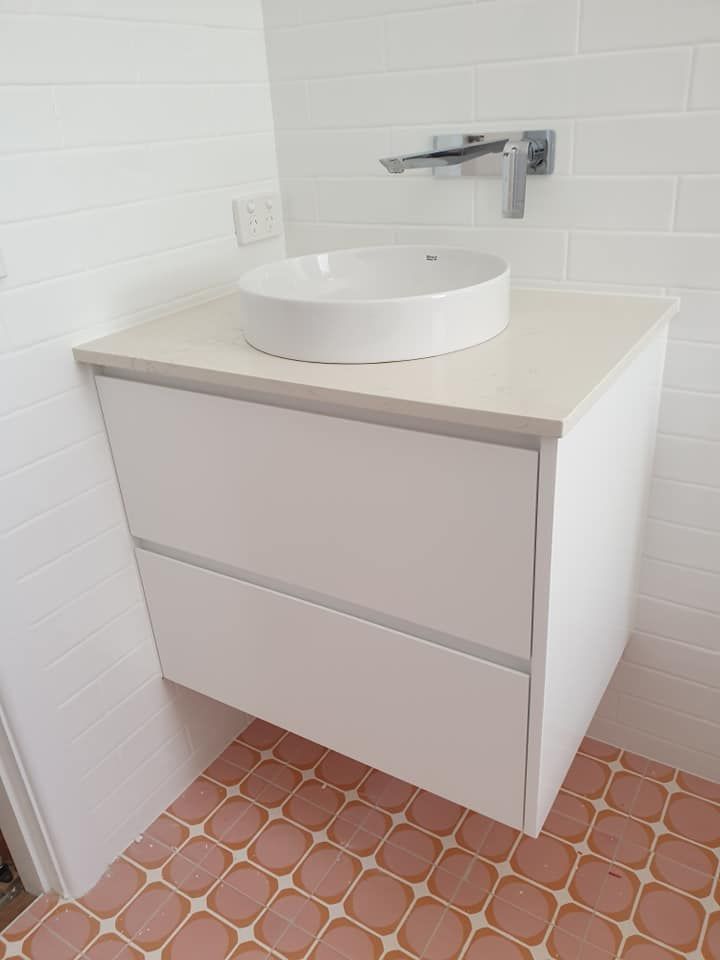 A Bathroom With a Sink and a Pink Tile Floor — Pacific Cabinets In Yamba, NSW
