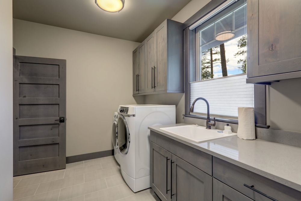 A Laundry Room With a Washer and Dryer and a Sink — Pacific Cabinets In Iluka, NSW