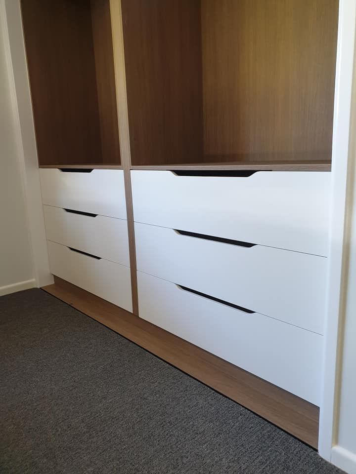A Walk in Closet With White Drawers and Wooden Shelves — Pacific Cabinets In Yamba, NSW