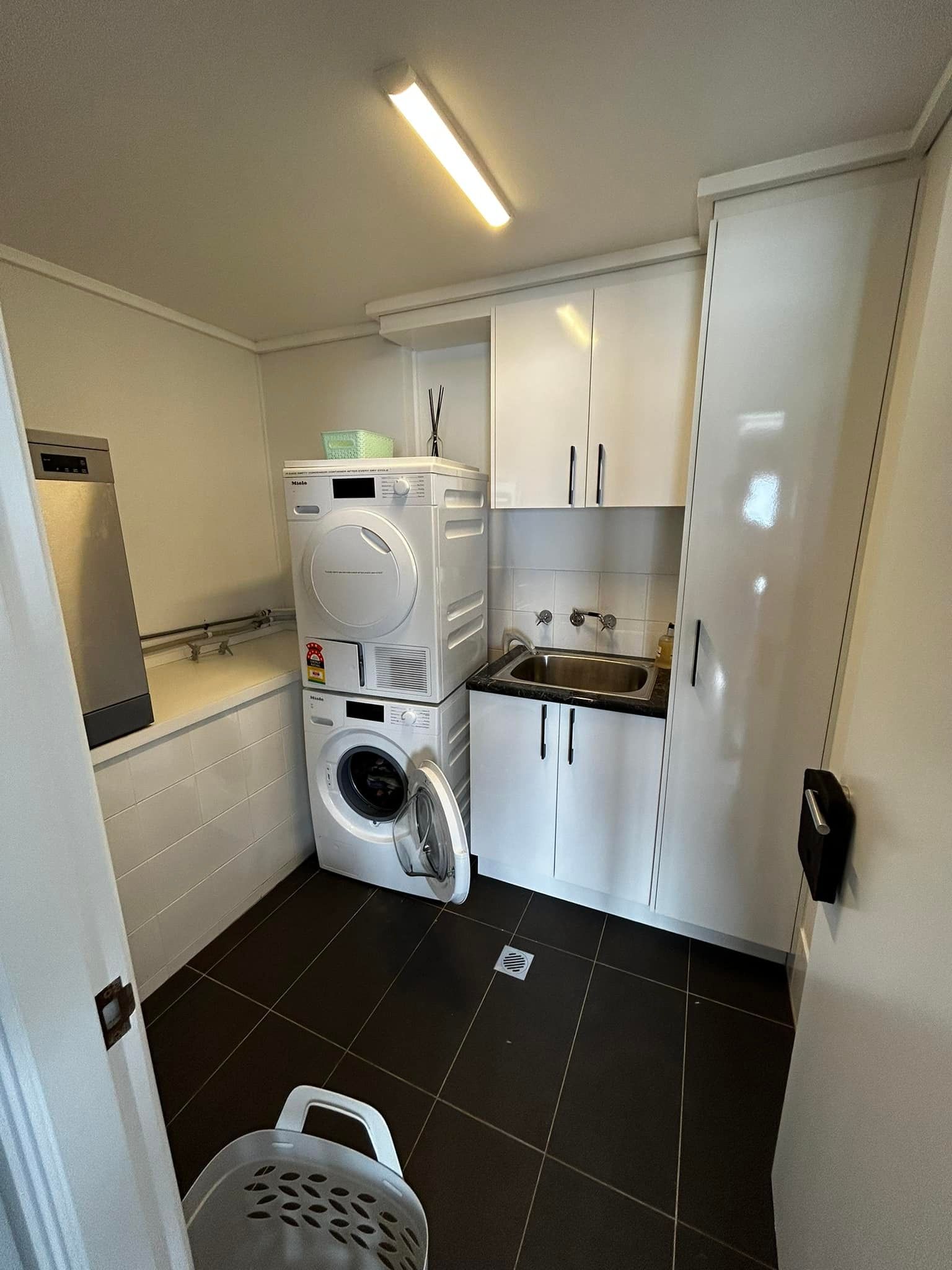 A Laundry Room With a Washer and Dryer — Pacific Cabinets In Yamba, NSW