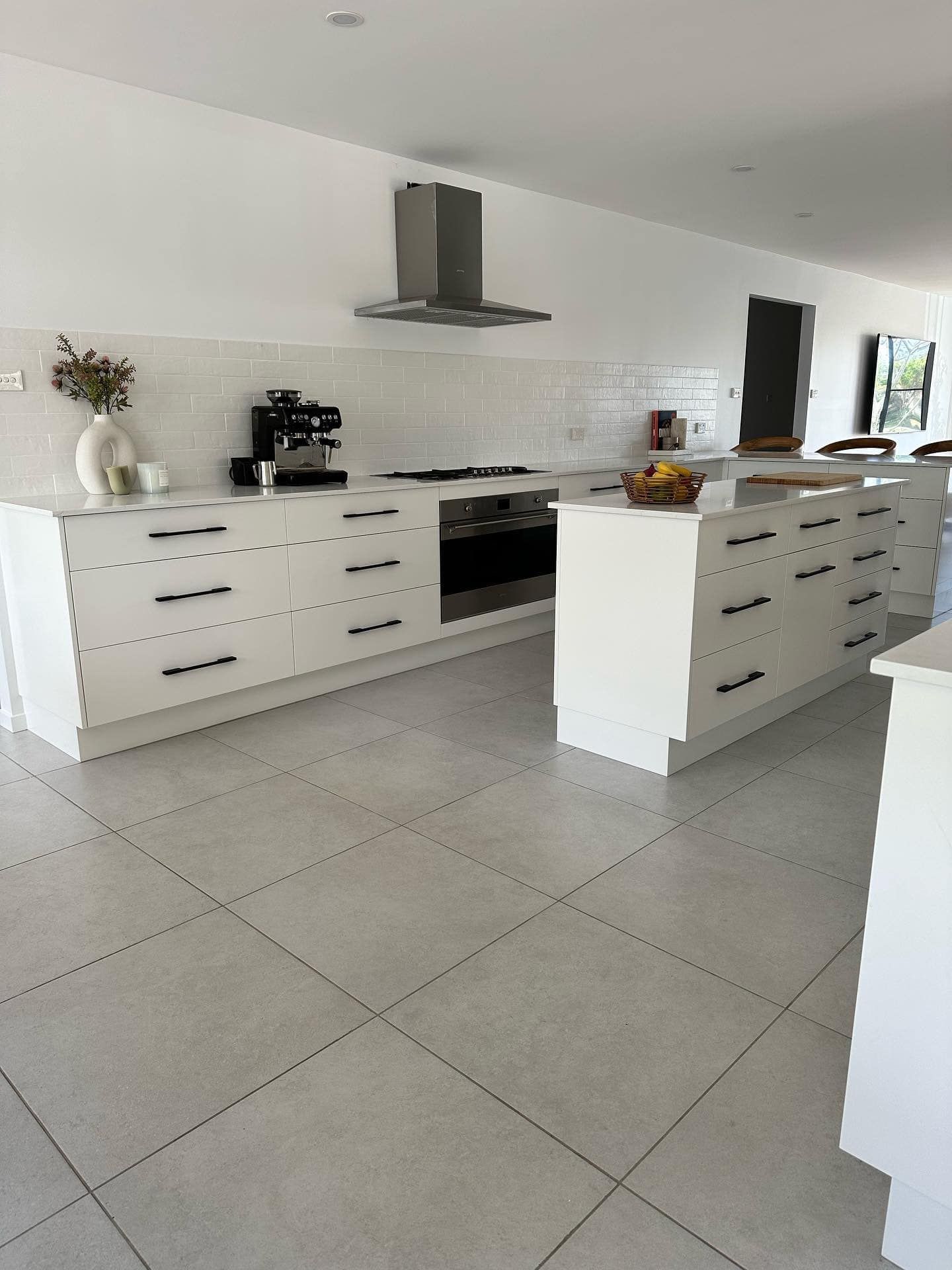 A Kitchen With White Cabinets , a Stove , a Sink , and a Hood — Pacific Cabinets In Yamba, NSW