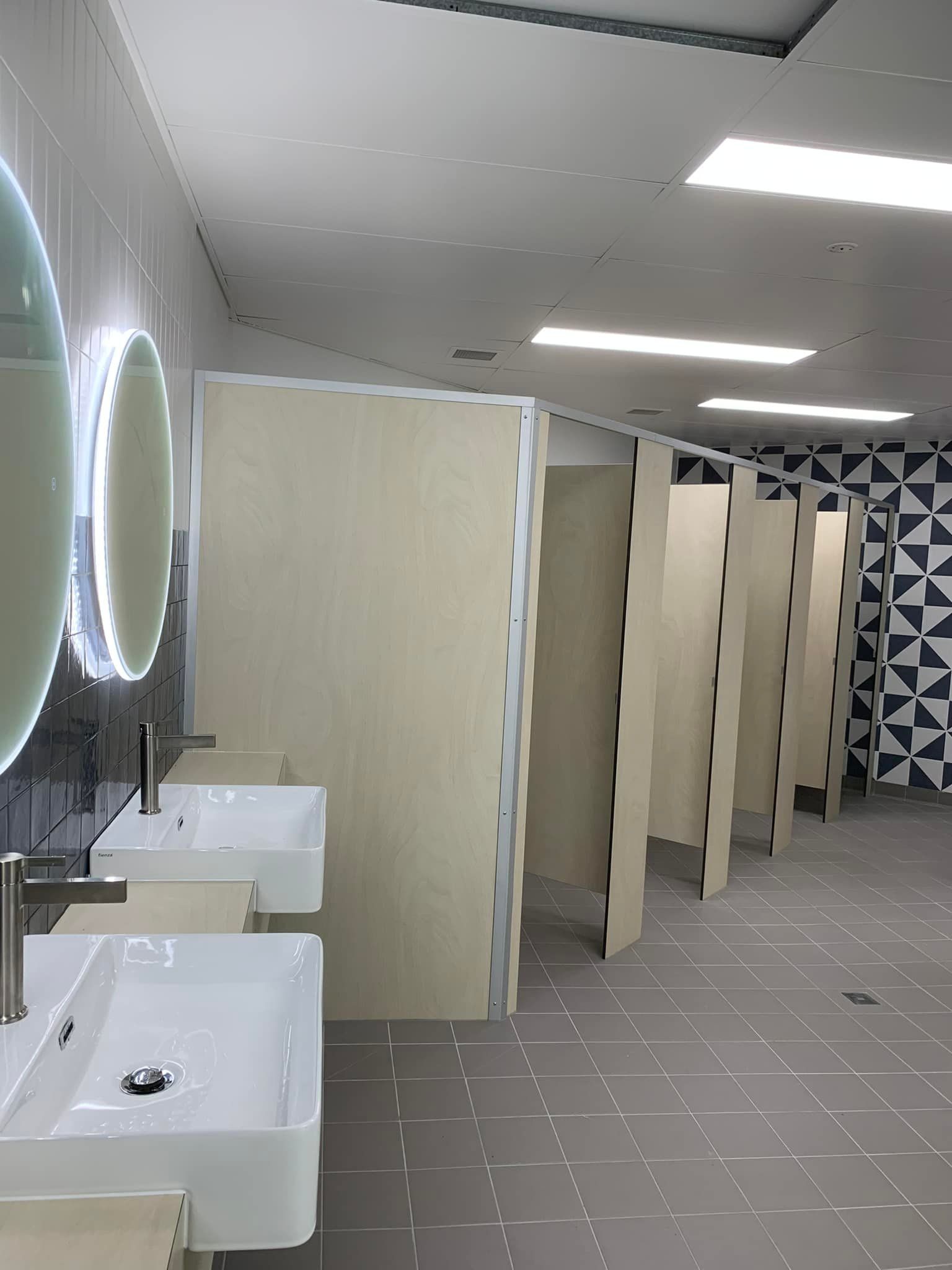 A Bathroom With a Row of Sinks and Toilets — Pacific Cabinets In Yamba, NSW