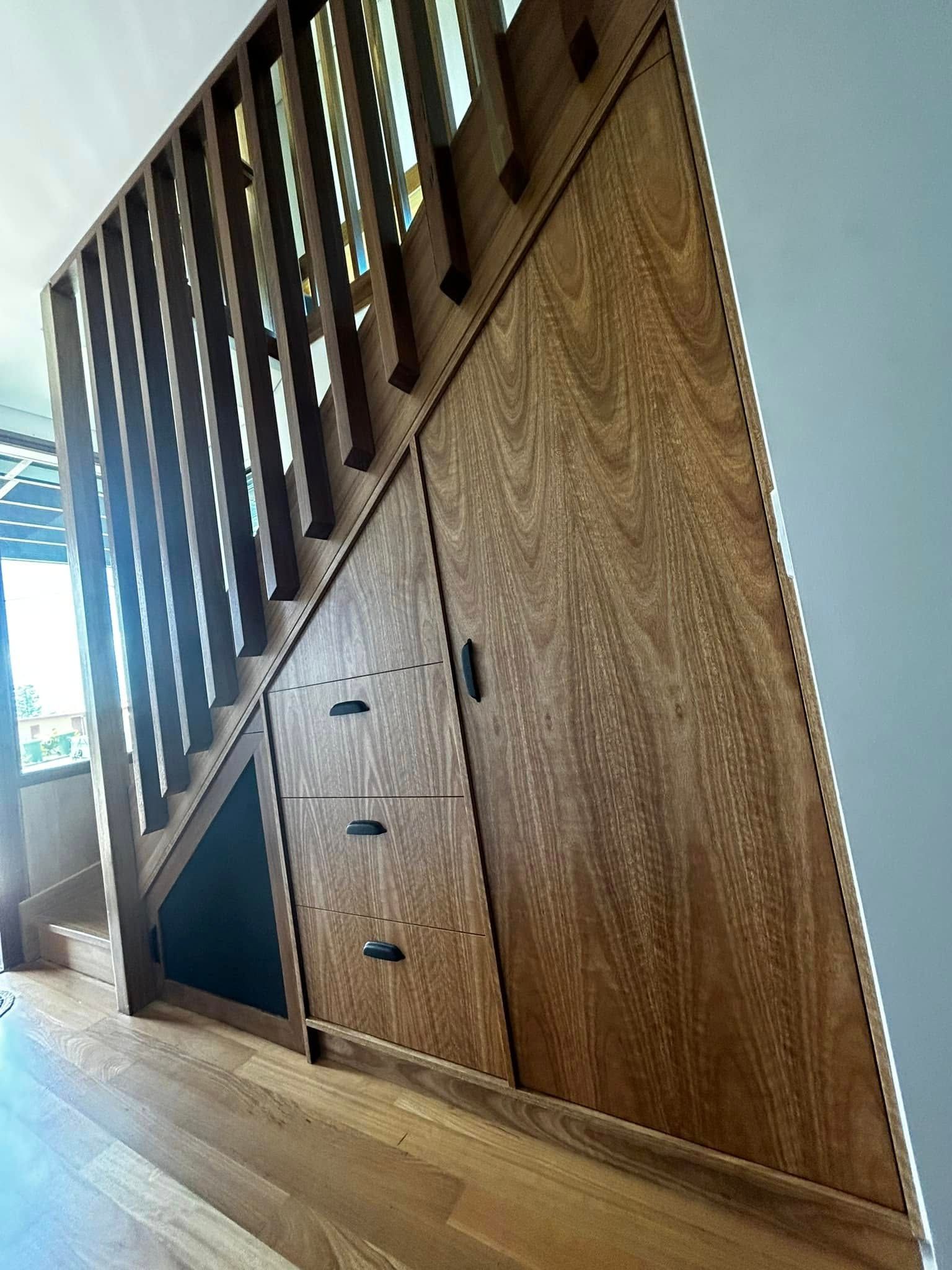 A Wooden Staircase With Drawers Underneath It and a Wooden Railing — Pacific Cabinets In Yamba, NSW