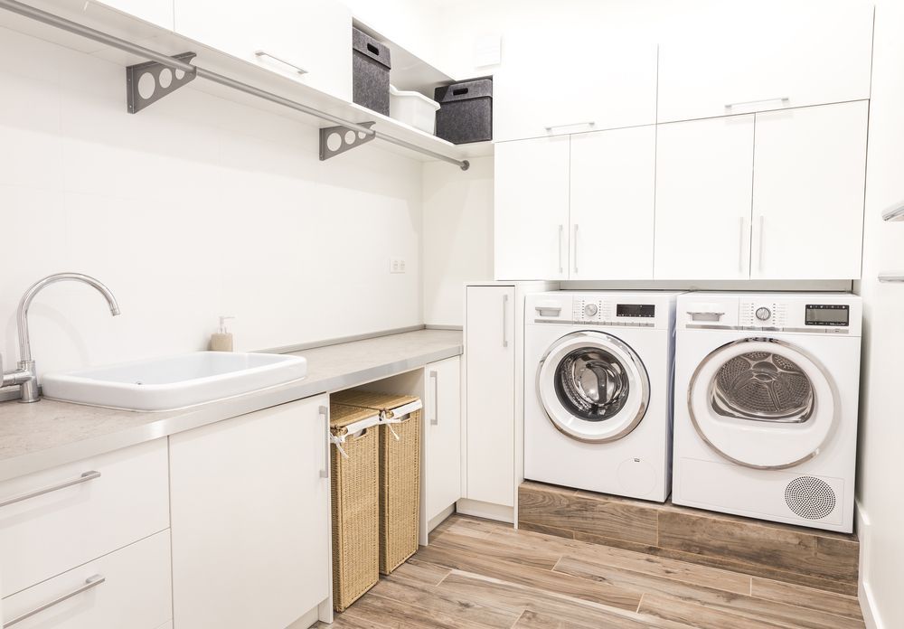 A Laundry Room With Two Washing Machines and a Sink — Pacific Cabinets In Maclean, NSW