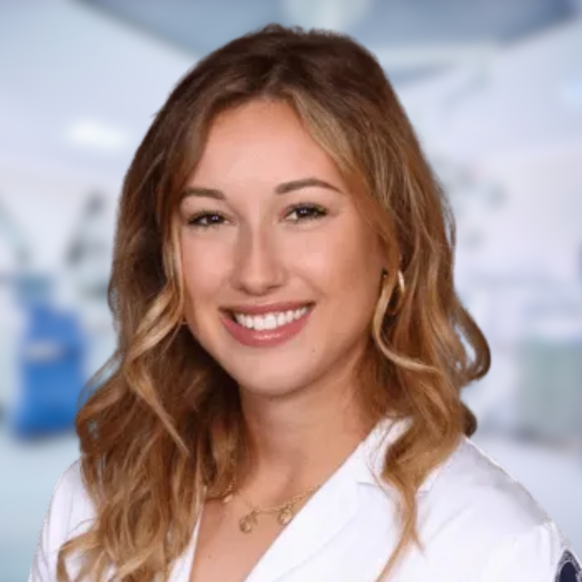 Smiling woman, Isabela P. PA-S, in a white coat, with a hospital backdrop.