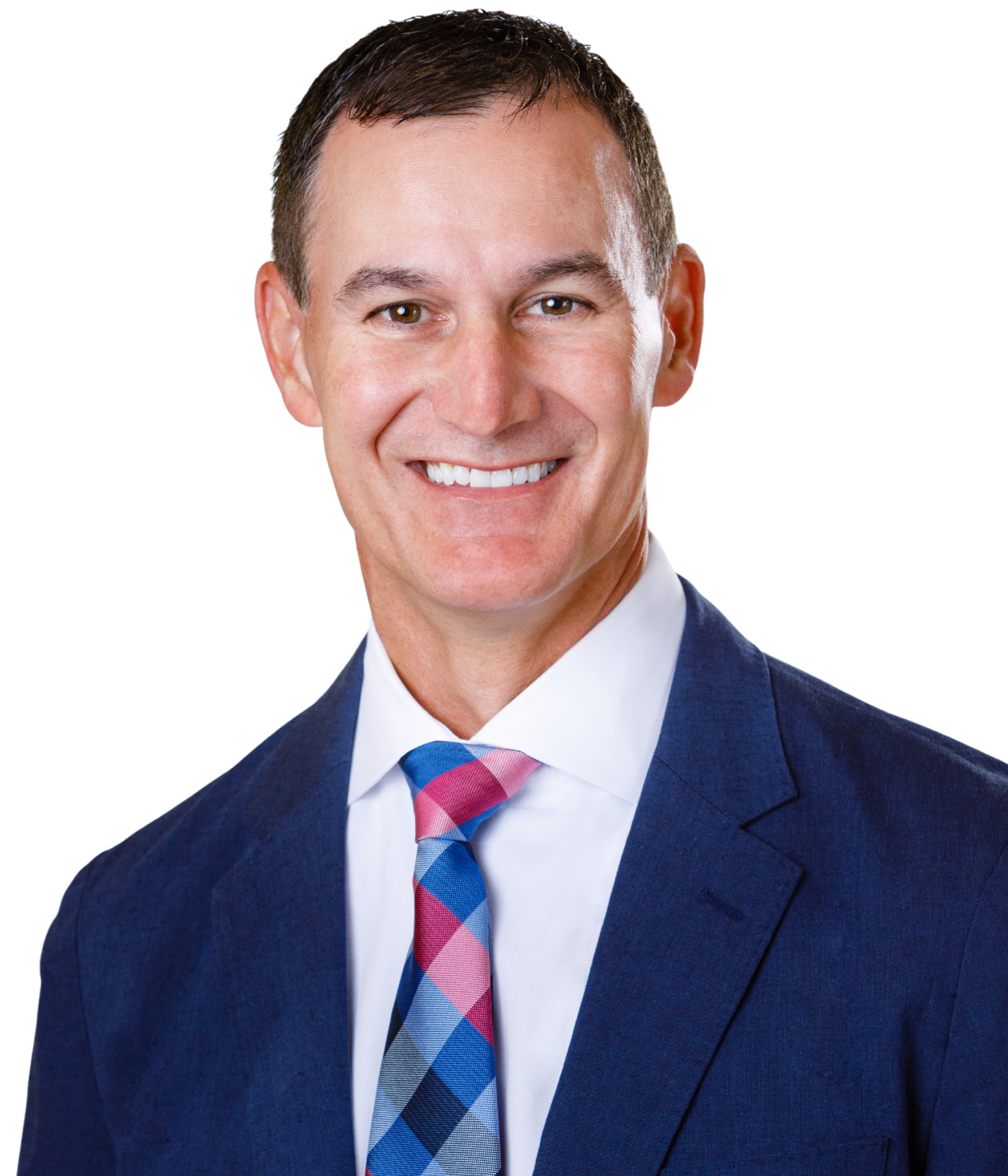Man in a blue suit and patterned tie, smiling at the camera.