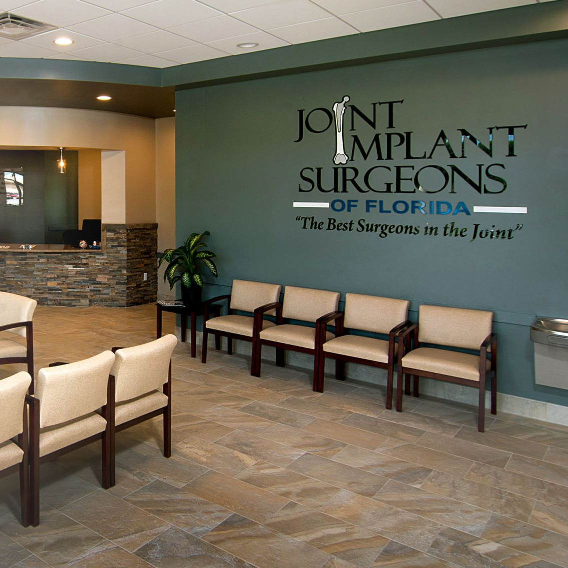 Doctor pointing at spinal column model, demonstrating spine anatomy.