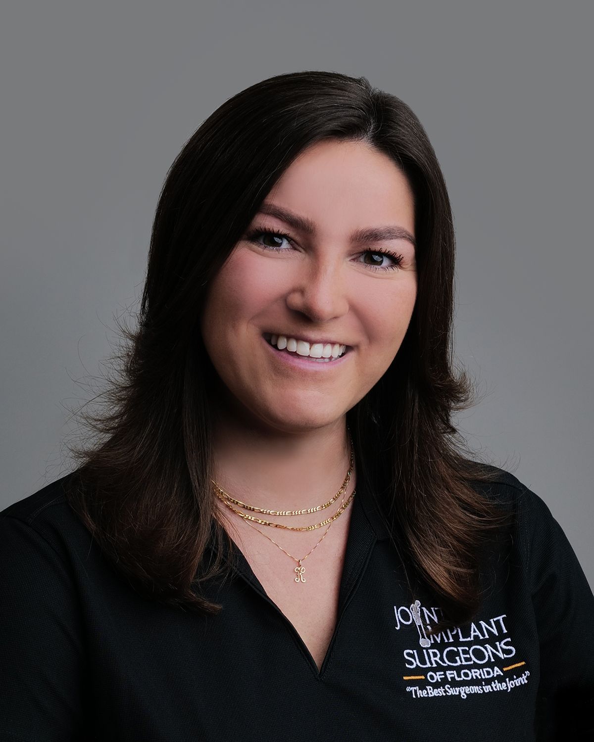 Smiling woman with auburn hair in a black shirt with 