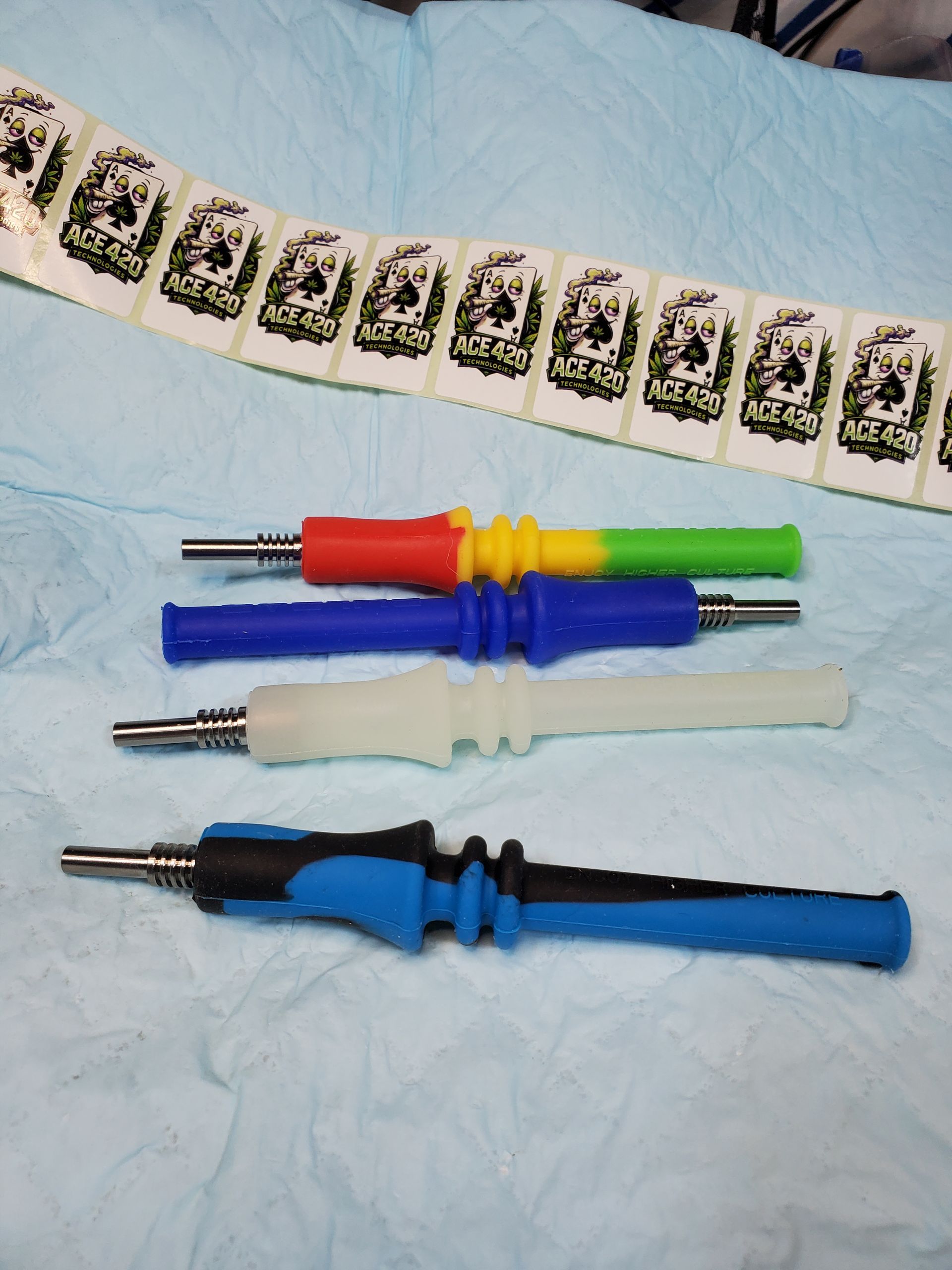 Four colorful audio/video cable adapters on a light blue cloth with a strip of film negatives above them
