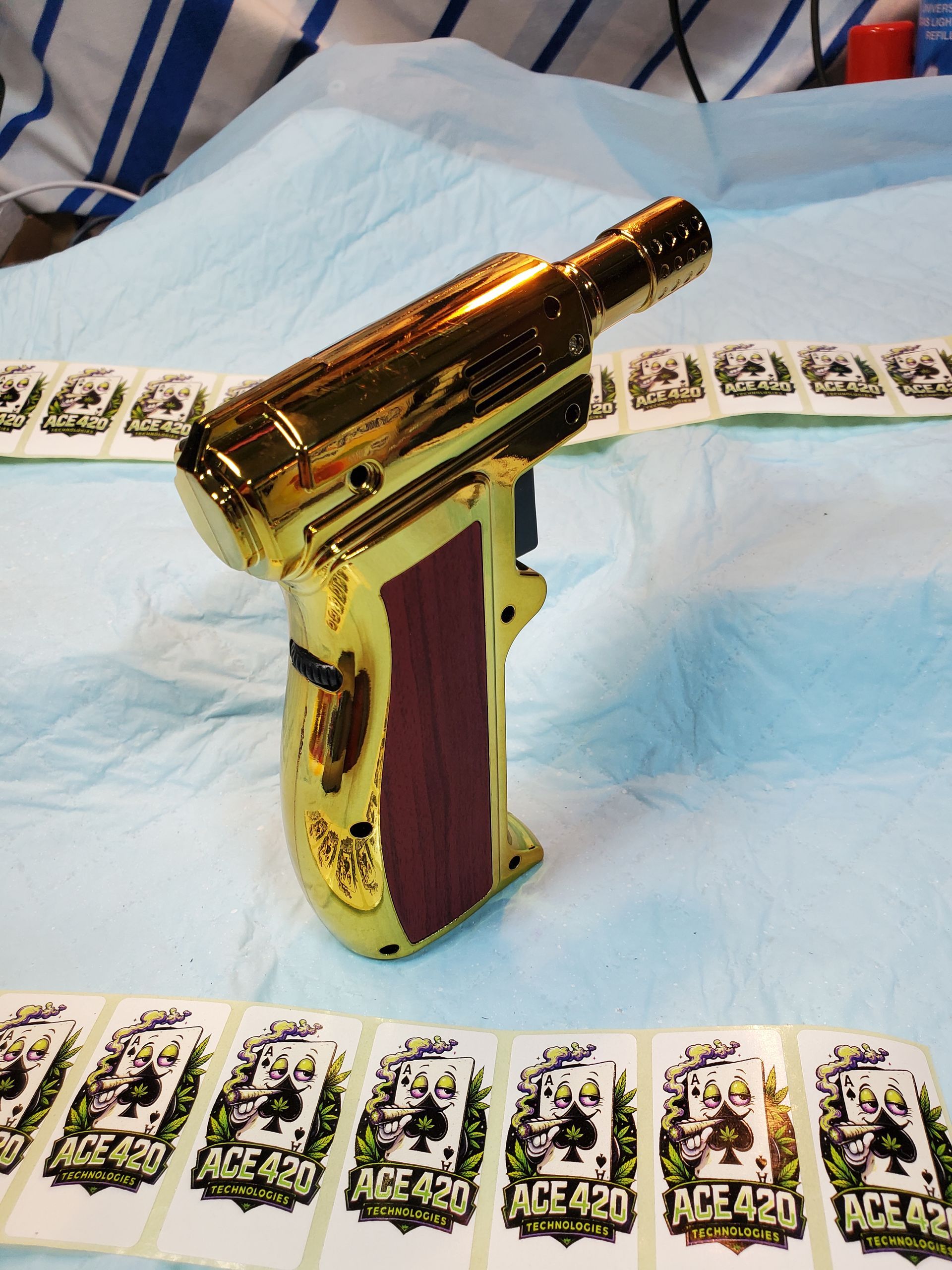 Gold toy gun on a bed with playing cards laid out around it