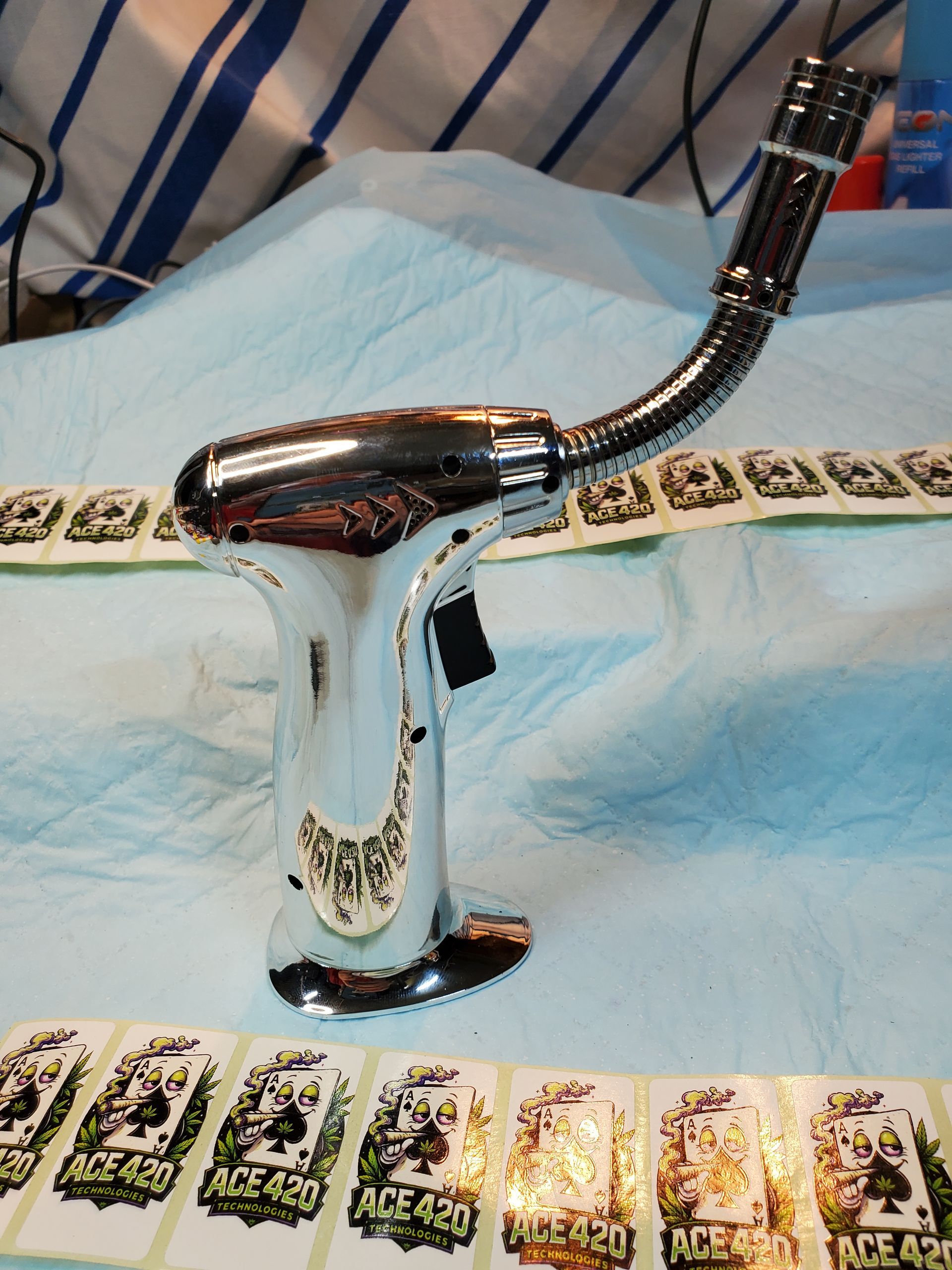 Chrome faucet handle on a white towel with a patterned strip on top and small cards below