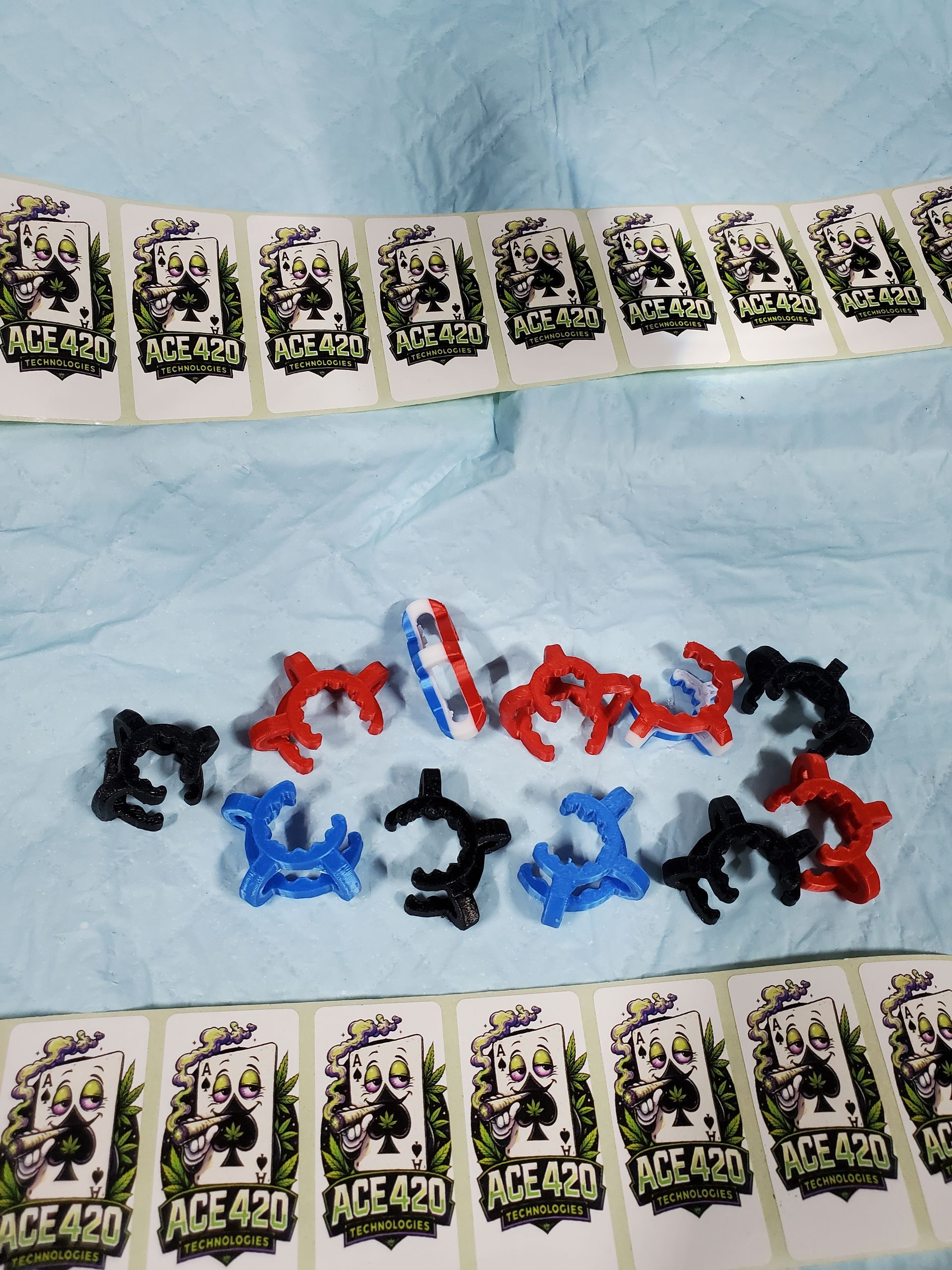 Assorted small colorful toys and cards arranged on a light blue cloth background