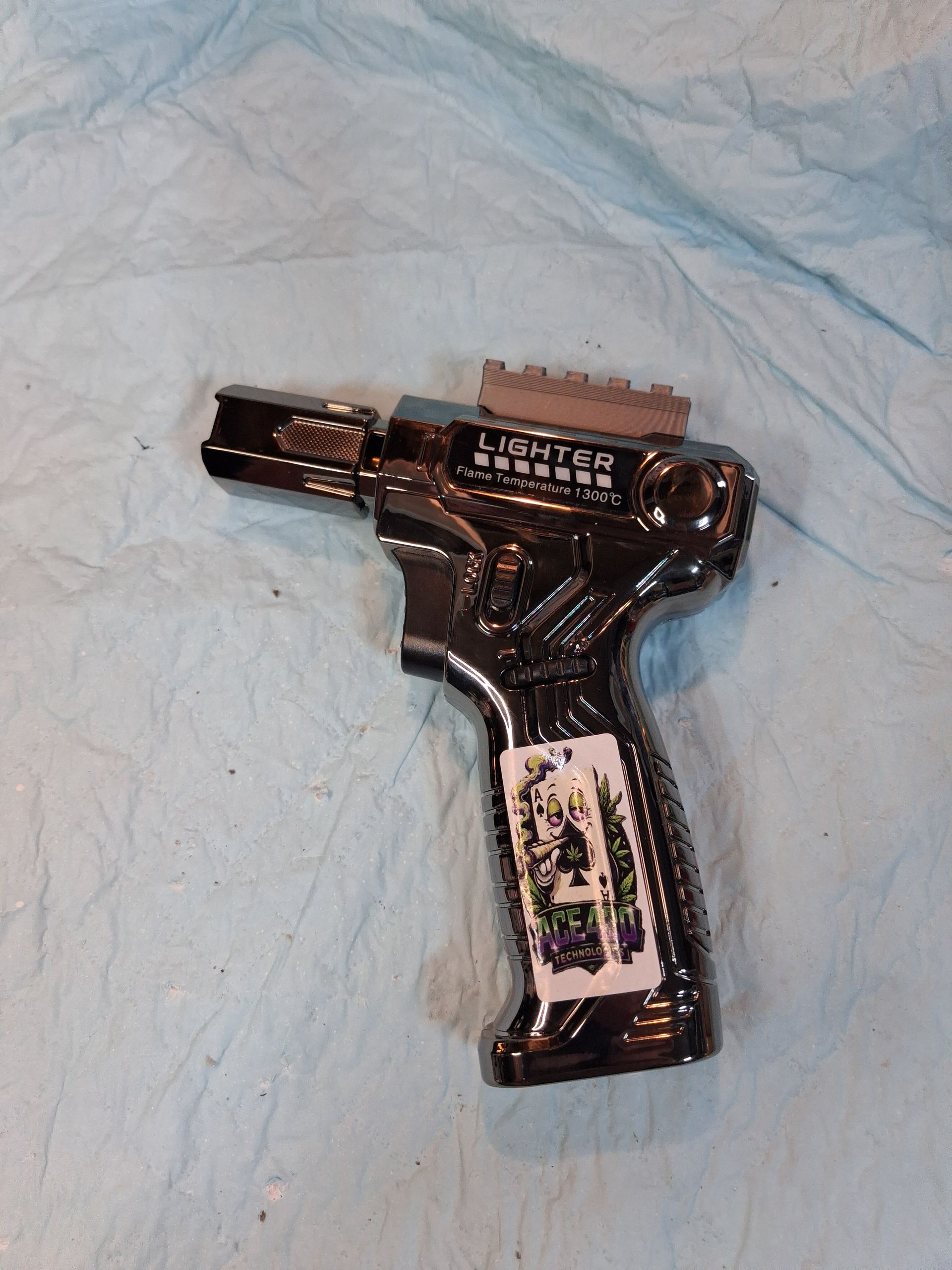 Black toy drill on a light blue cloth background