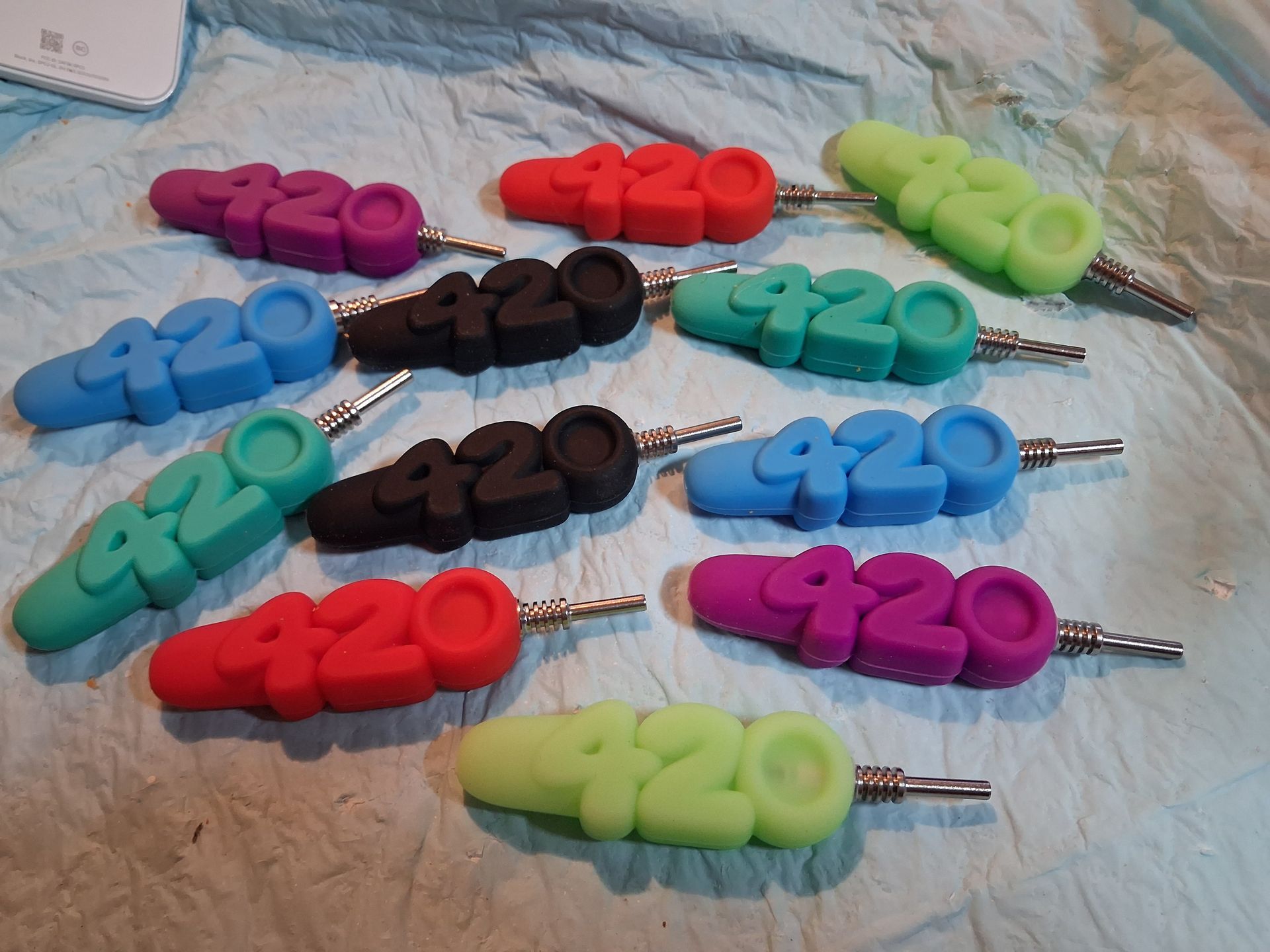 Colorful numbered clip-on keychains arranged on fabric background