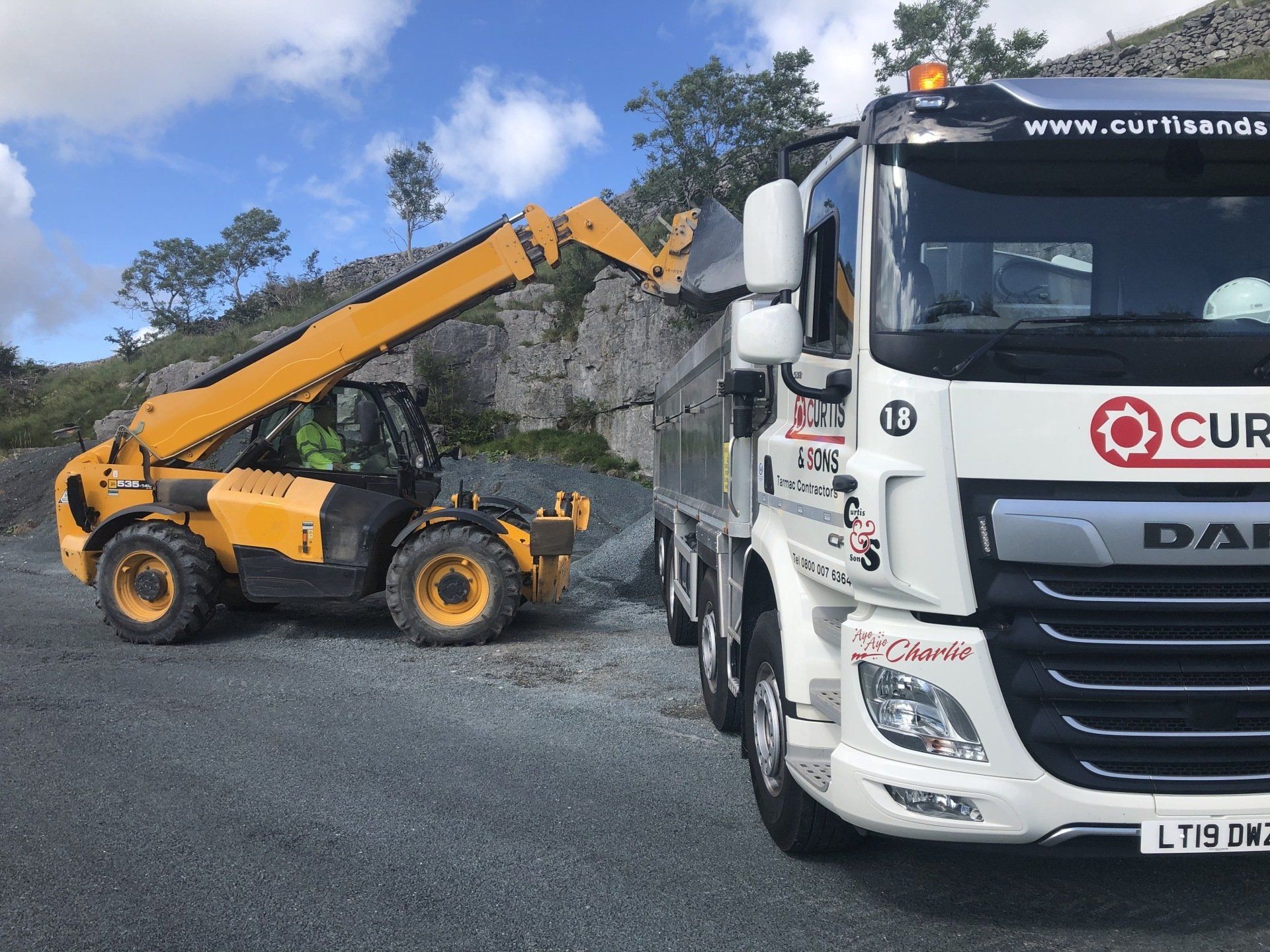 Tractor moving small stones