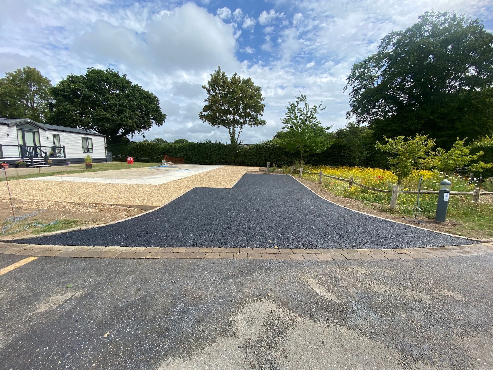 A road with a lot of gravel and trees on the side of it.
