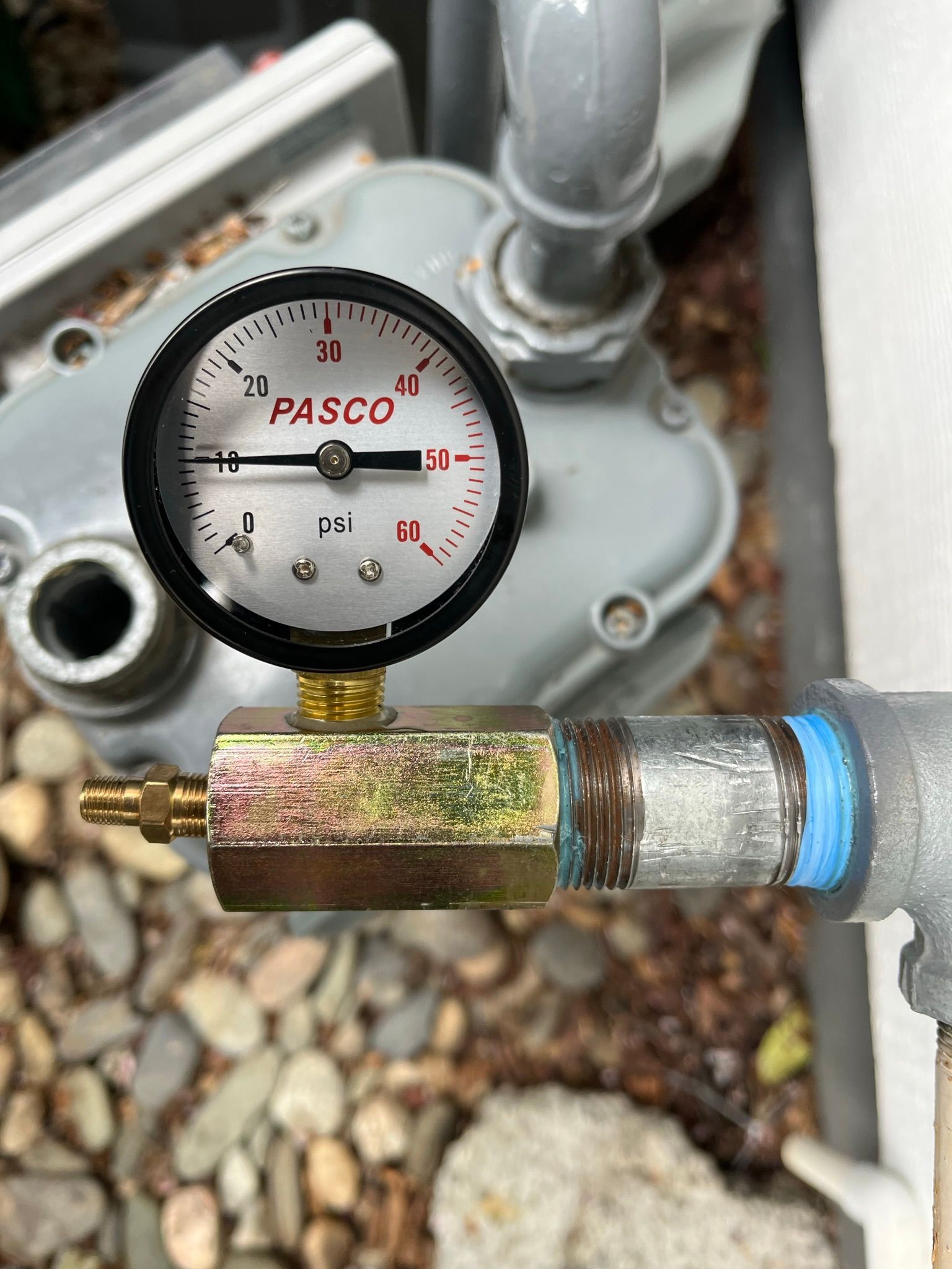 A pasco pressure gauge is attached to a pipe.