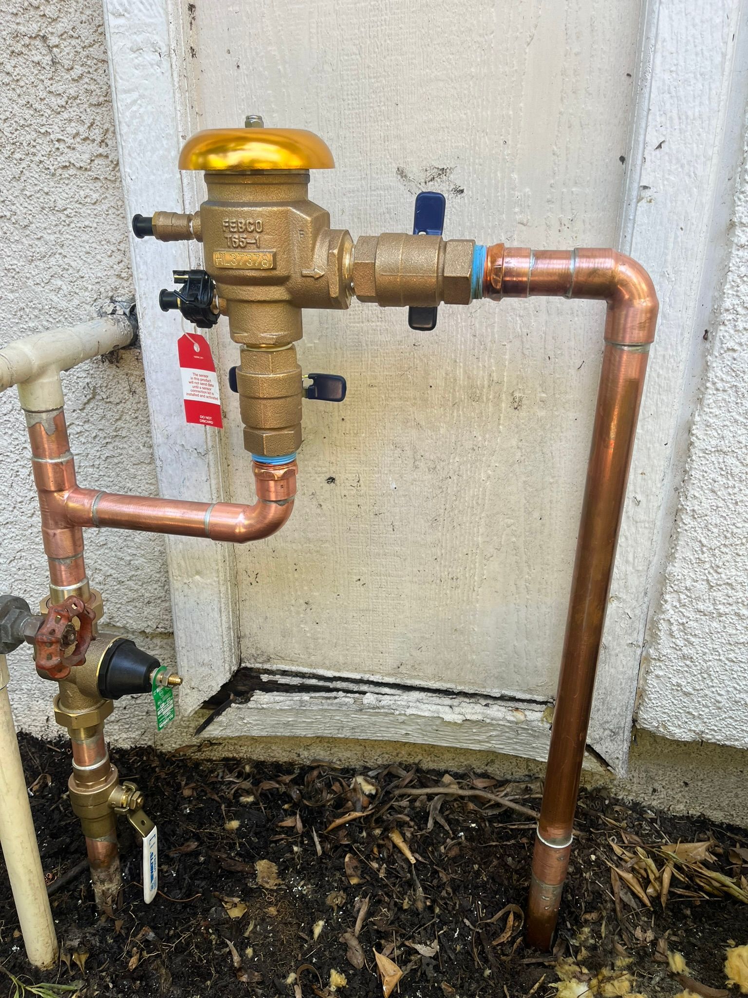 A close up of a copper pipe with a valve attached to it.