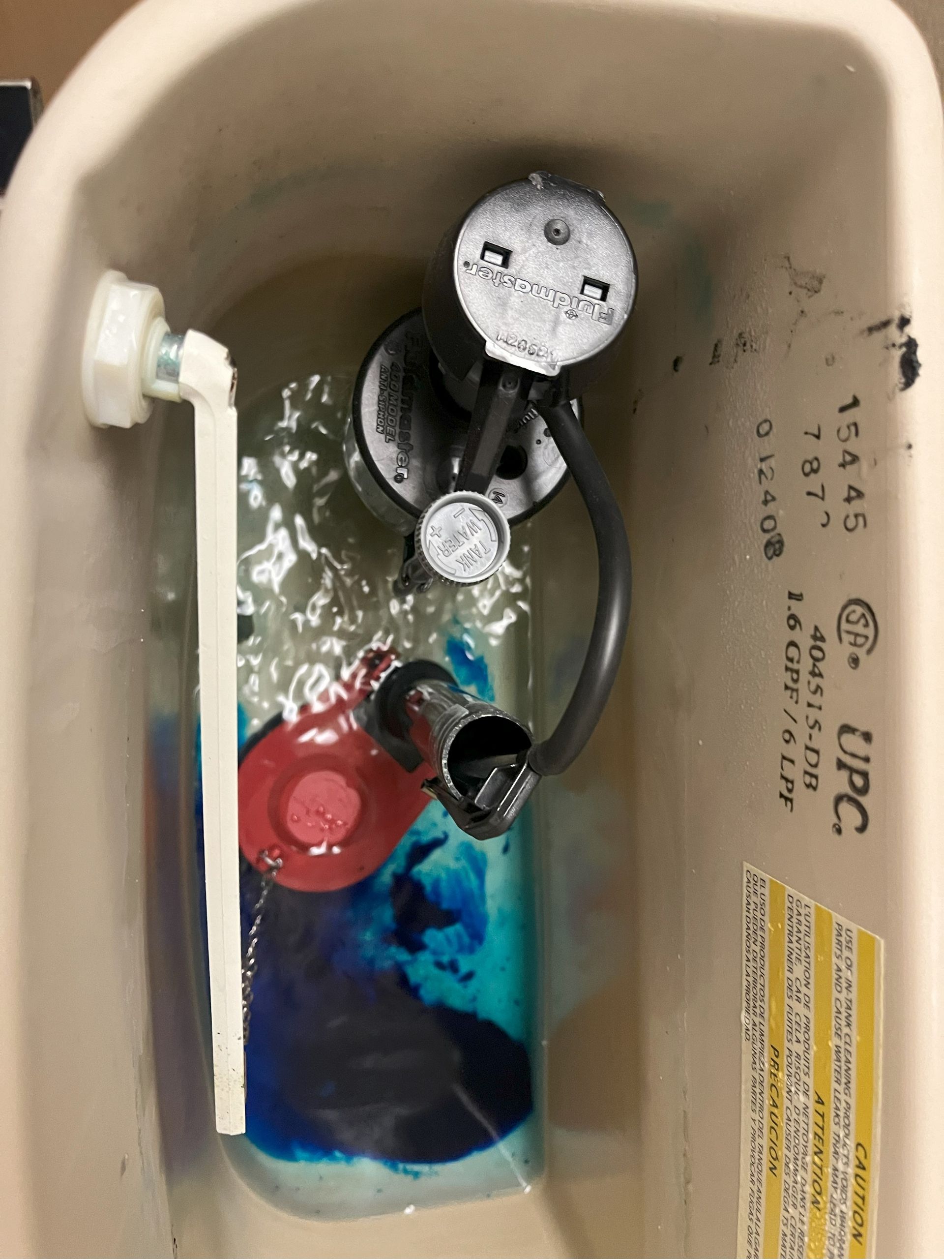 The inside of a toilet tank with the word upc on it